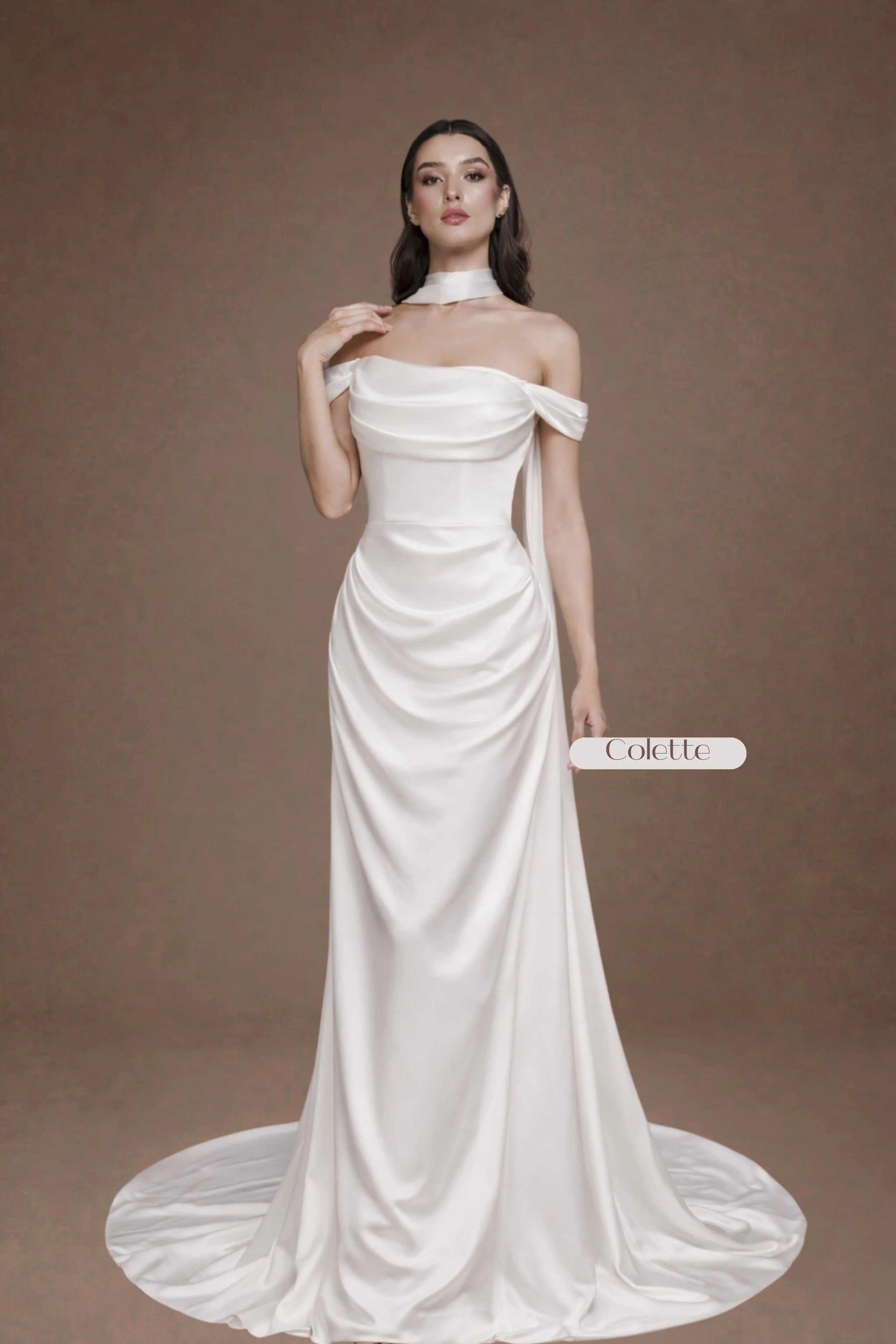 Victorian-inspired silk satin wedding gown with draped neckline, detachable off-shoulder sleeves, mermaid silhouette, draped front, 19-inch train, zipper back with buttons, and matching neck scarf.