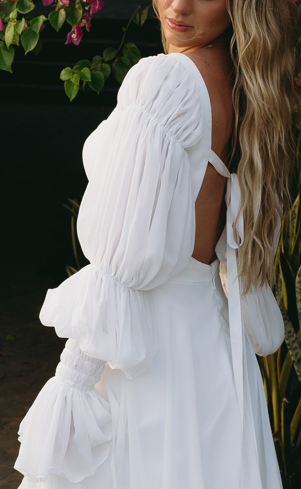 Romantic square neck wedding dress with puff sleeves, open back, and flowing chiffon A-line skirt. Akmaral Bridal