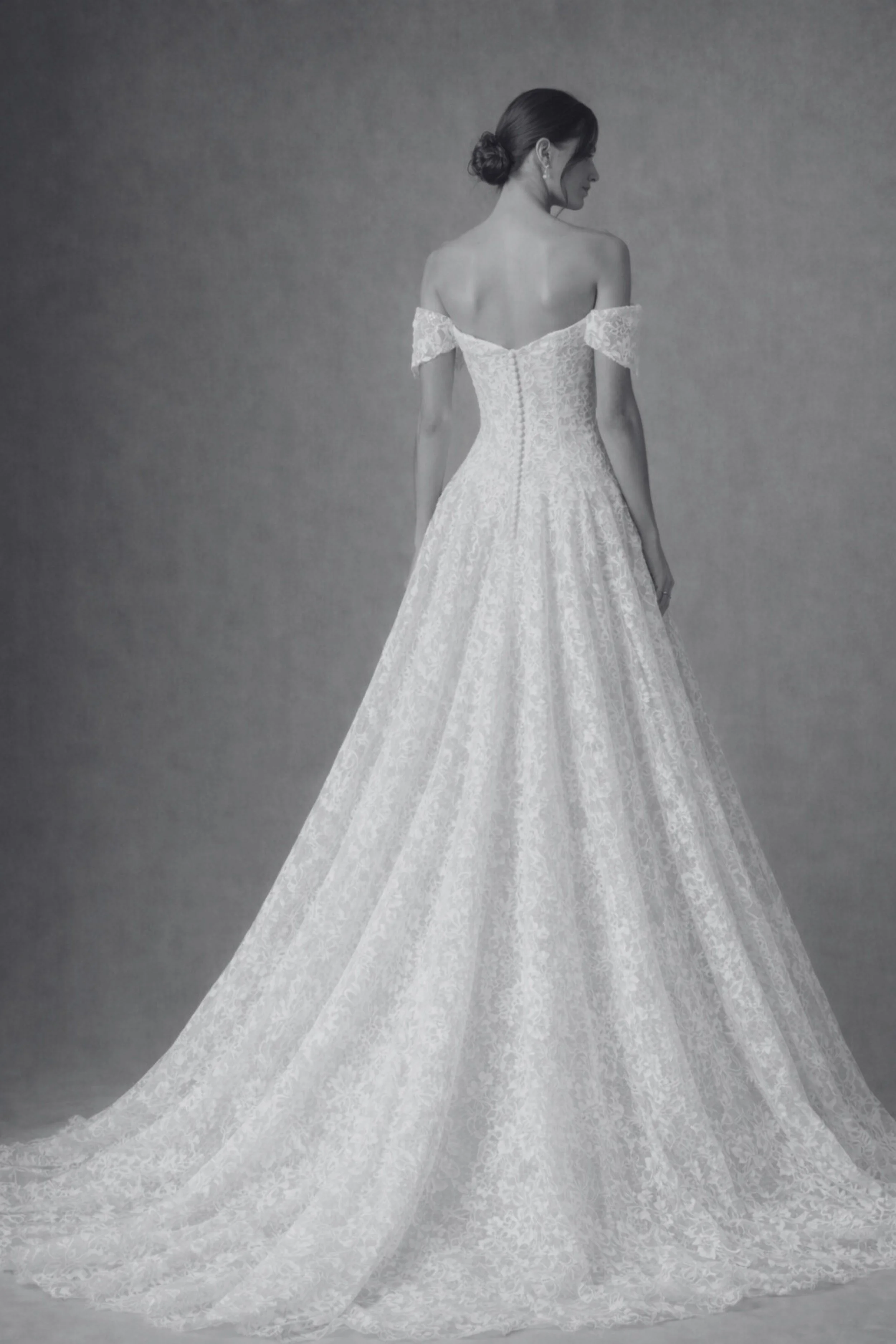 Off the shoulder lace wedding dress with fitted corset bodice, A-line skirt, and elegant train