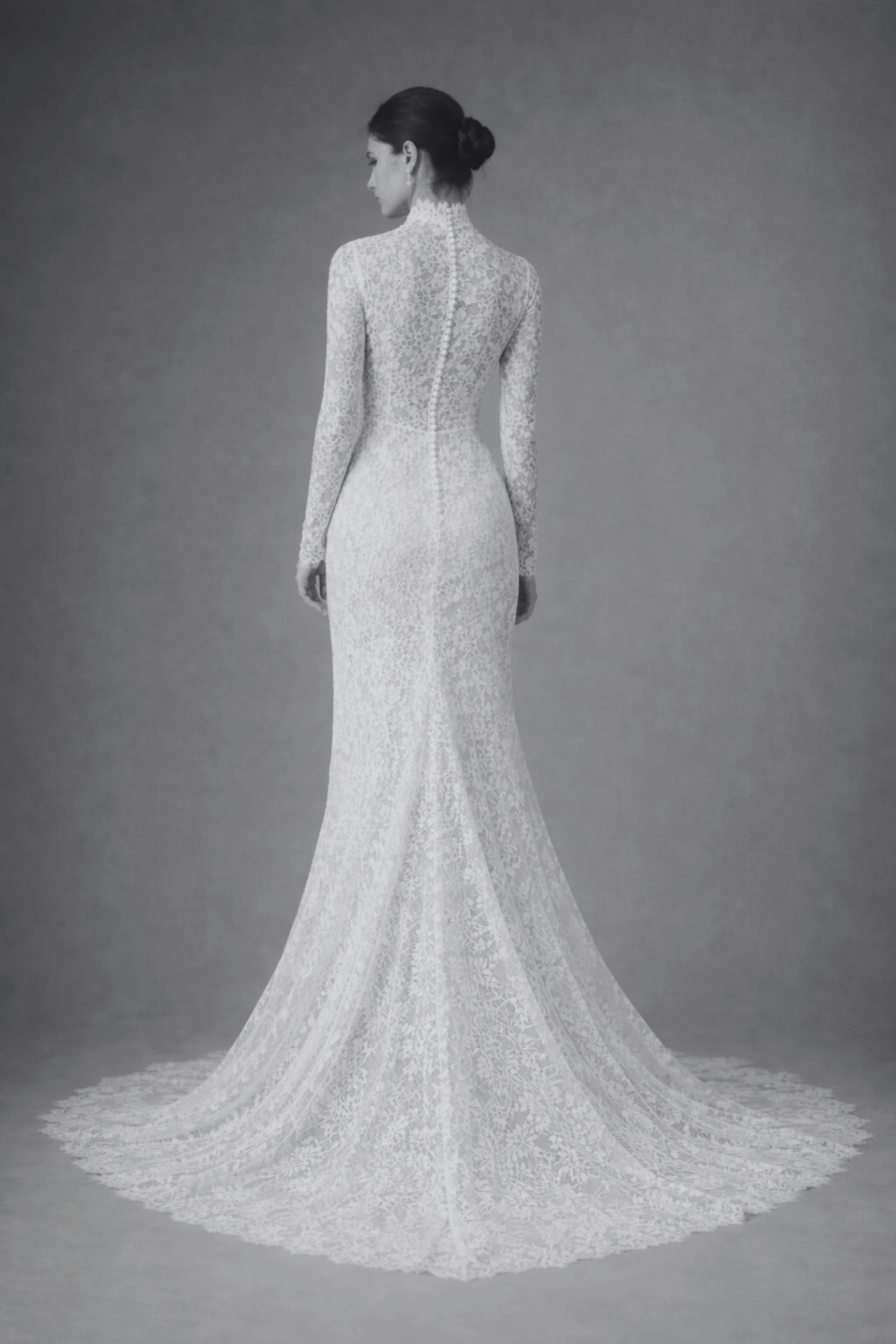 Back view of lace bridal gown with long sleeves, high neck, covered buttons.