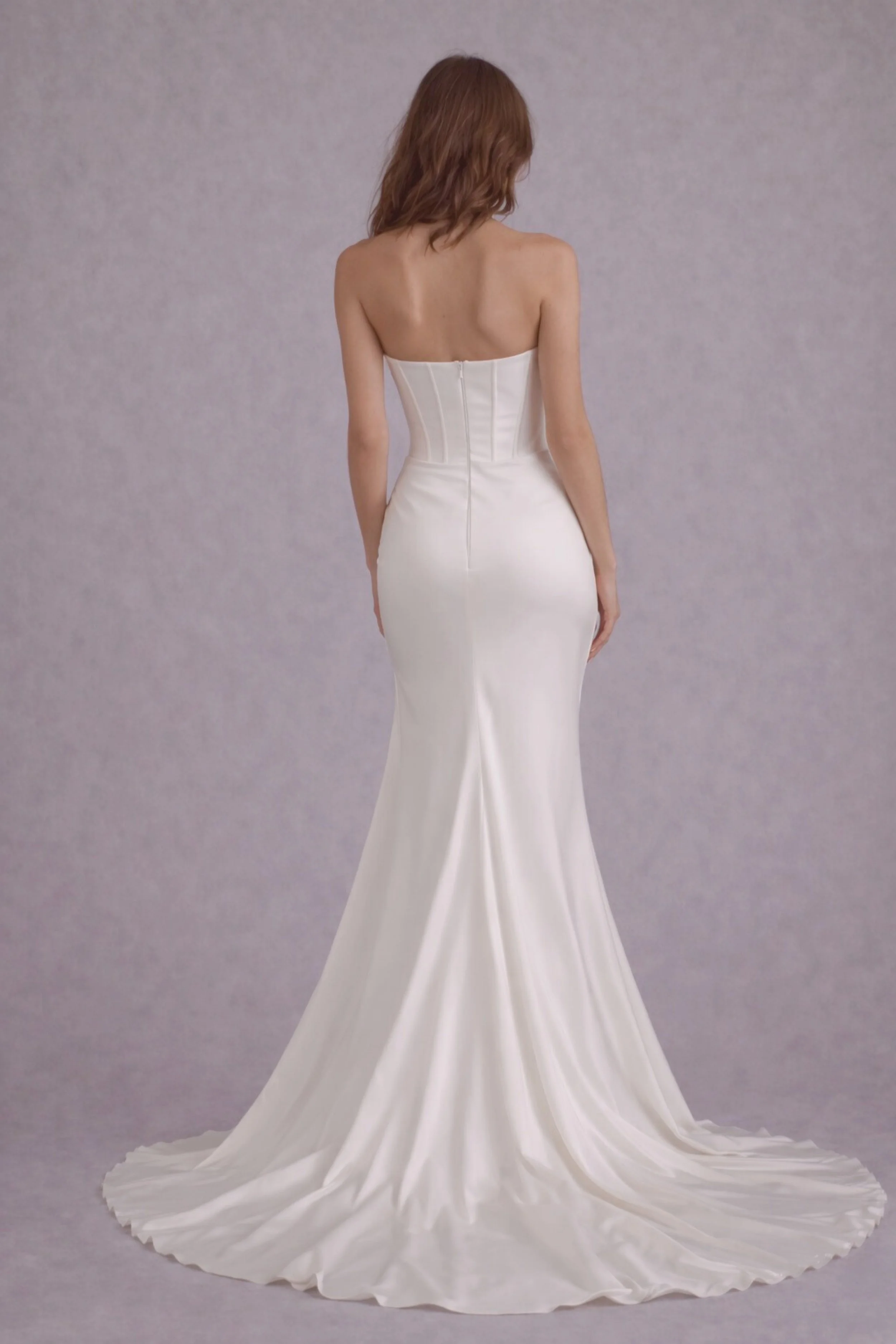Strapless satin mermaid wedding dress with corset bodice, sleek fit and elegant flowing train