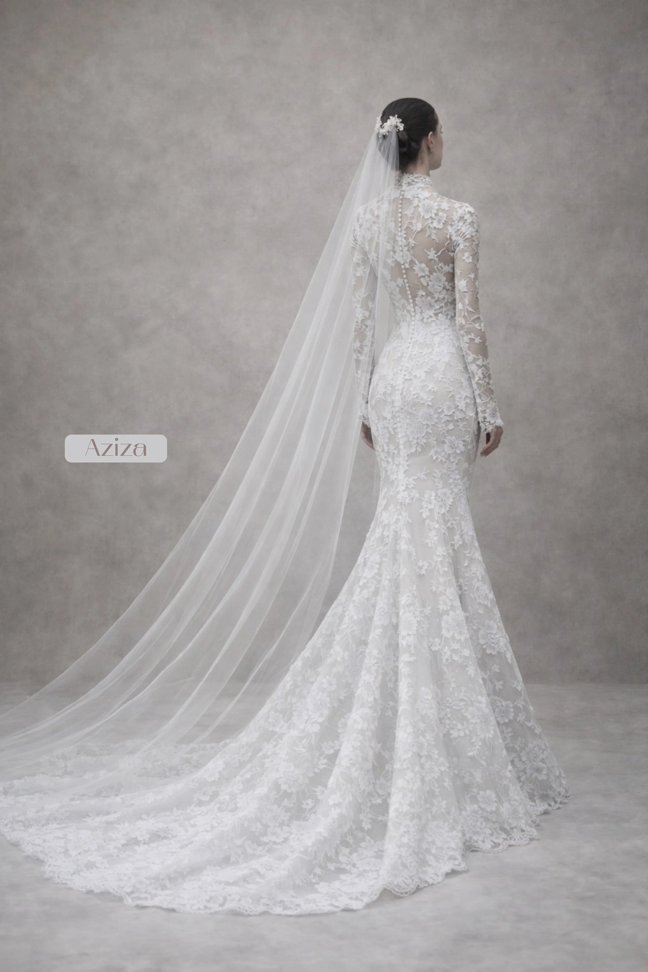 Aziza lace wedding dress with long sleeves and mermaid silhouette, sculpted fit, floral lace, illusion bodice, open back with scalloped edges, and flowing lace train in elegant ivory.