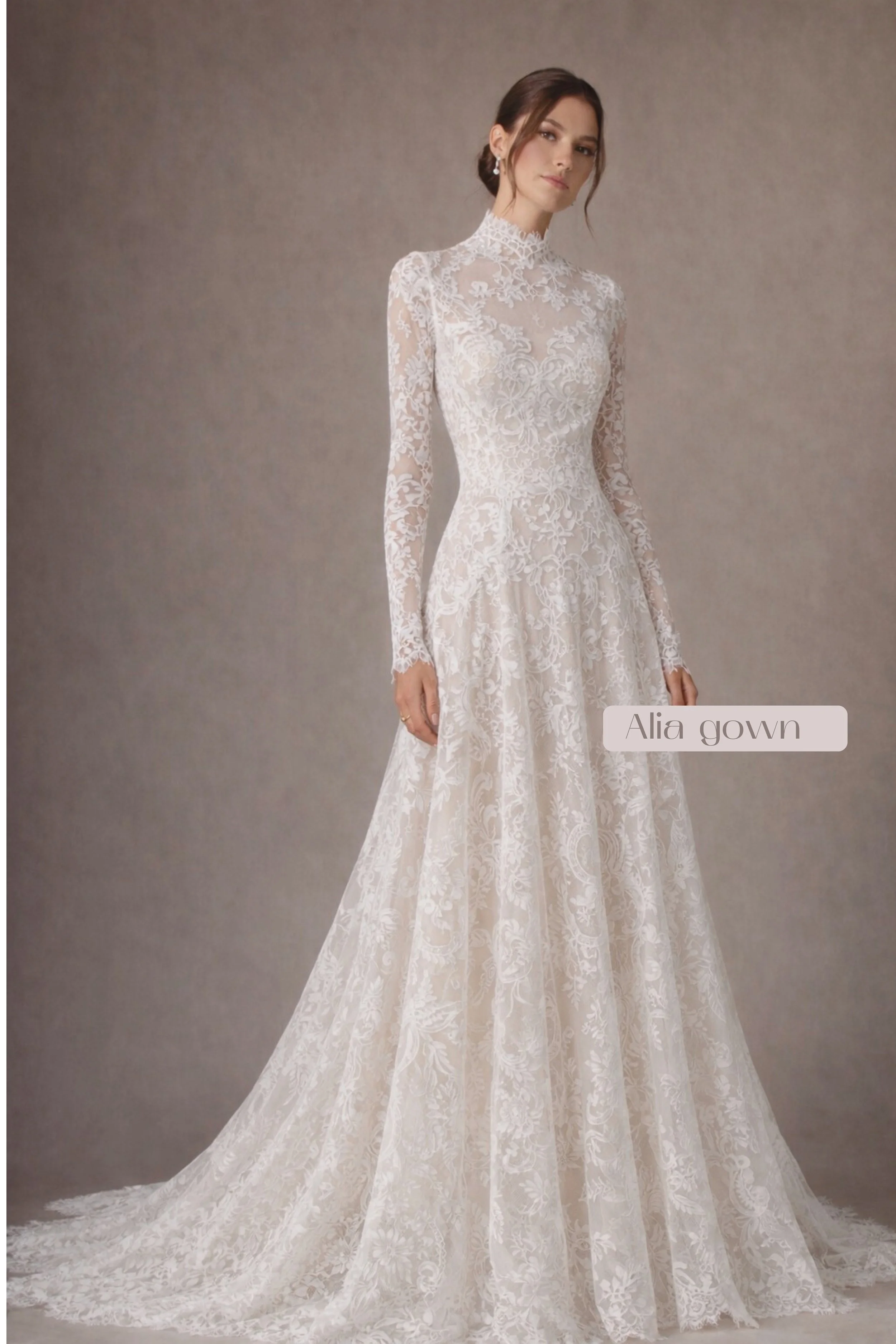 Long-sleeve lace wedding dress with high neckline, button-back bodice, and flowing A-line skirt