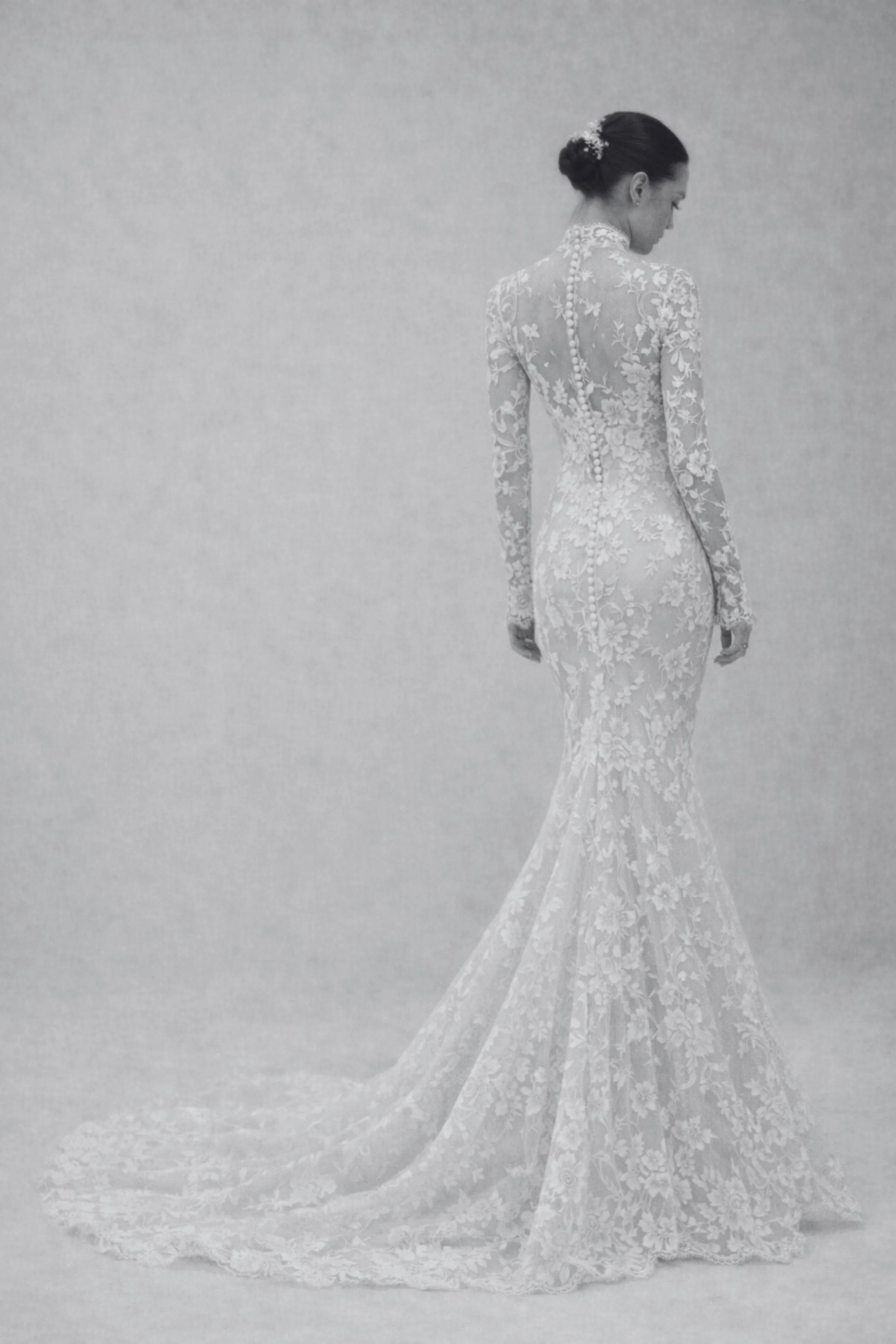 Aziza lace wedding dress with long sleeves and mermaid silhouette, sculpted fit, floral lace, illusion bodice, open back with scalloped edges, and flowing lace train in elegant ivory.