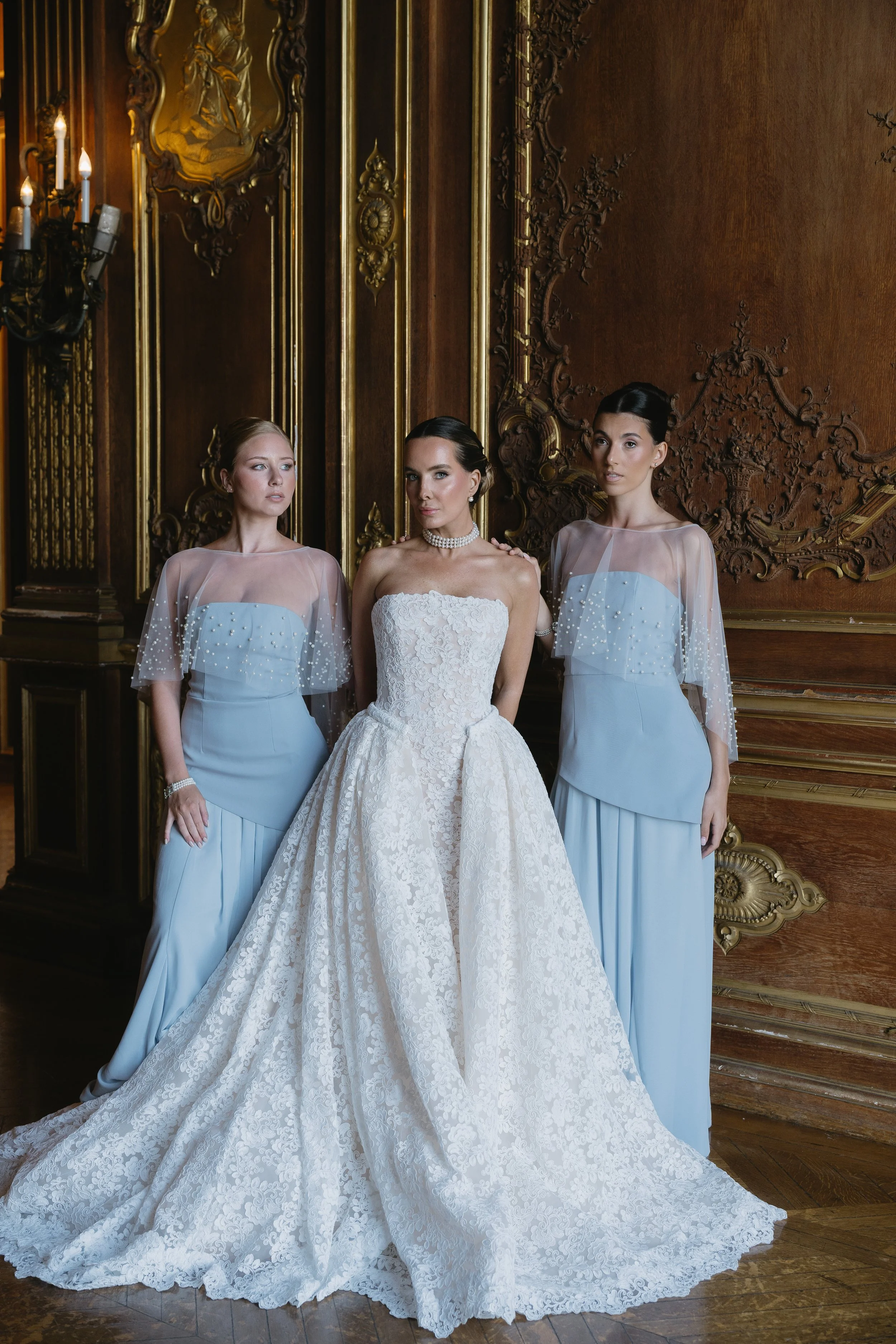 Convertible strapless lace wedding dress with a fitted sheath silhouette, detachable A-line overskirt, floral lace, and cathedral train.