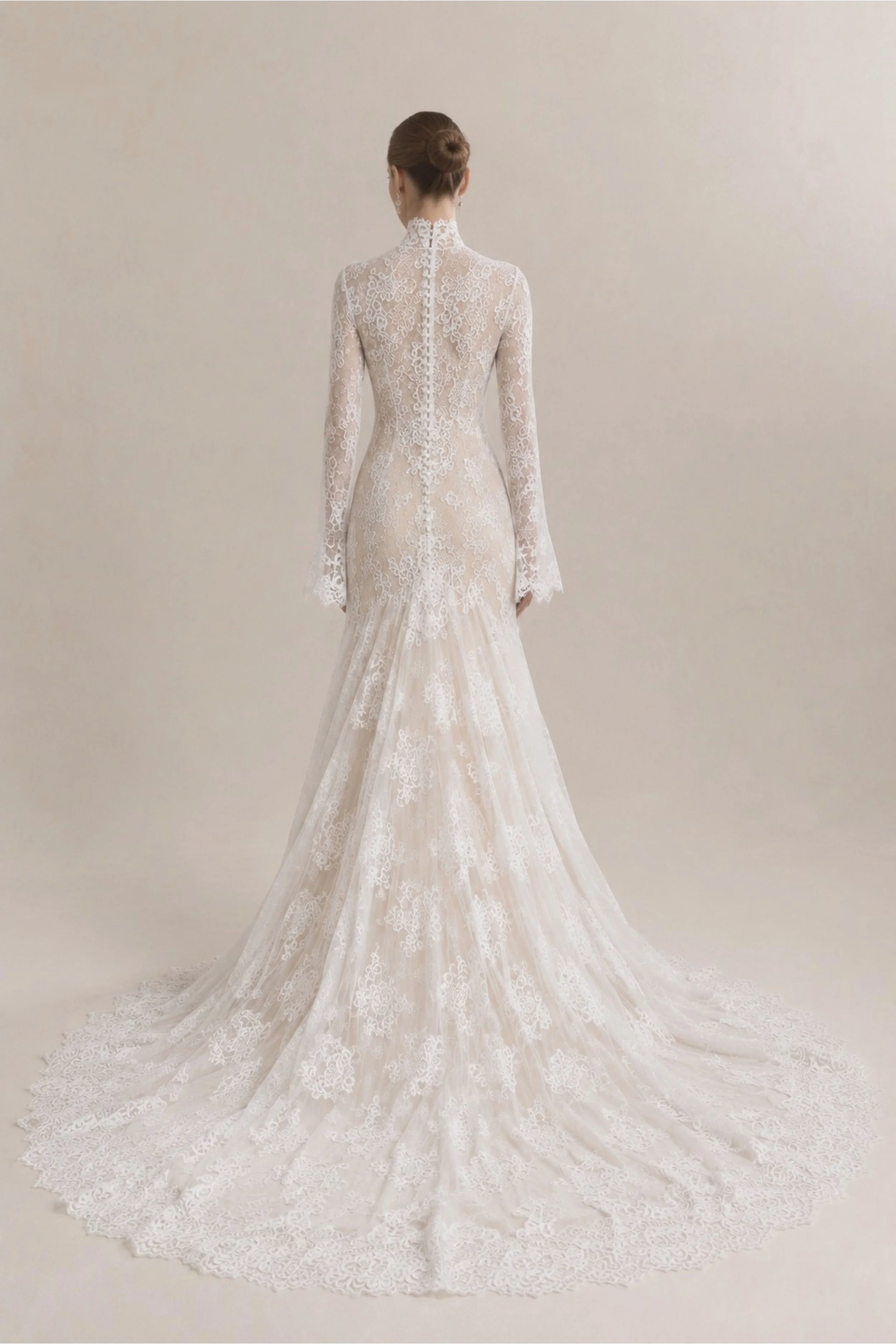 Long sleeve high neck Chantilly lace wedding dress with flared mermaid skirt, scalloped train and cathedral veil for a classic modern bride.
