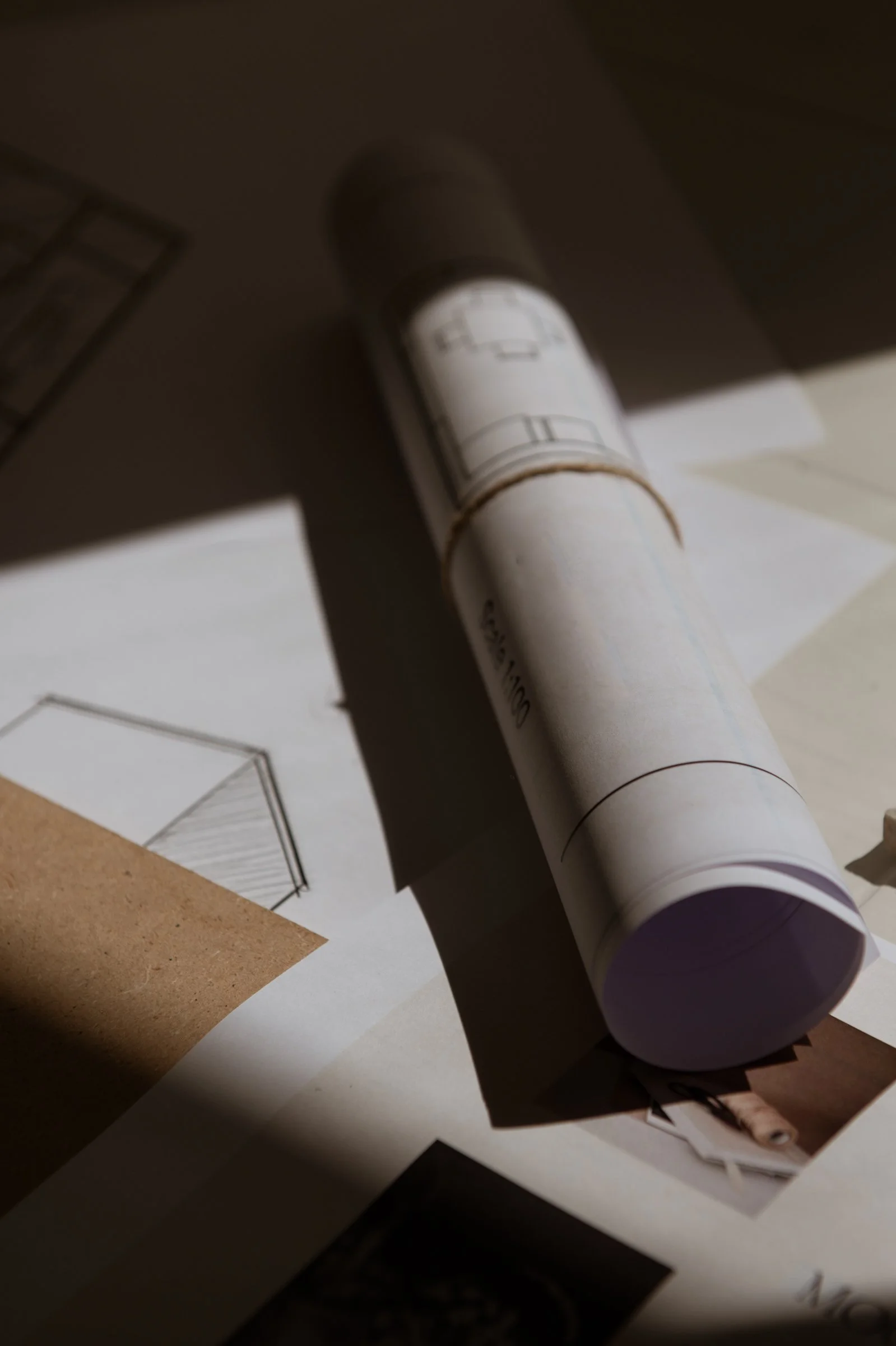 A set of plans rolled up on a table