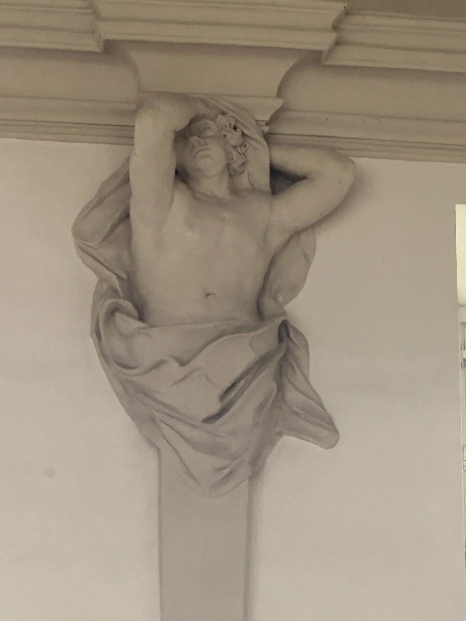 A stone carving high up near the ceiling