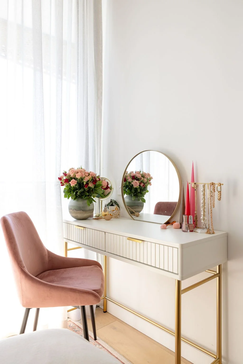 A pretty girl's room with vanity and pink velvet chair.