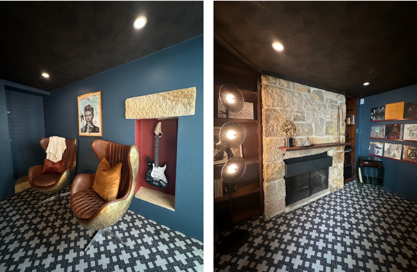 A room with bright colour, two tub chairs and an electric guitar in a coloured niche.