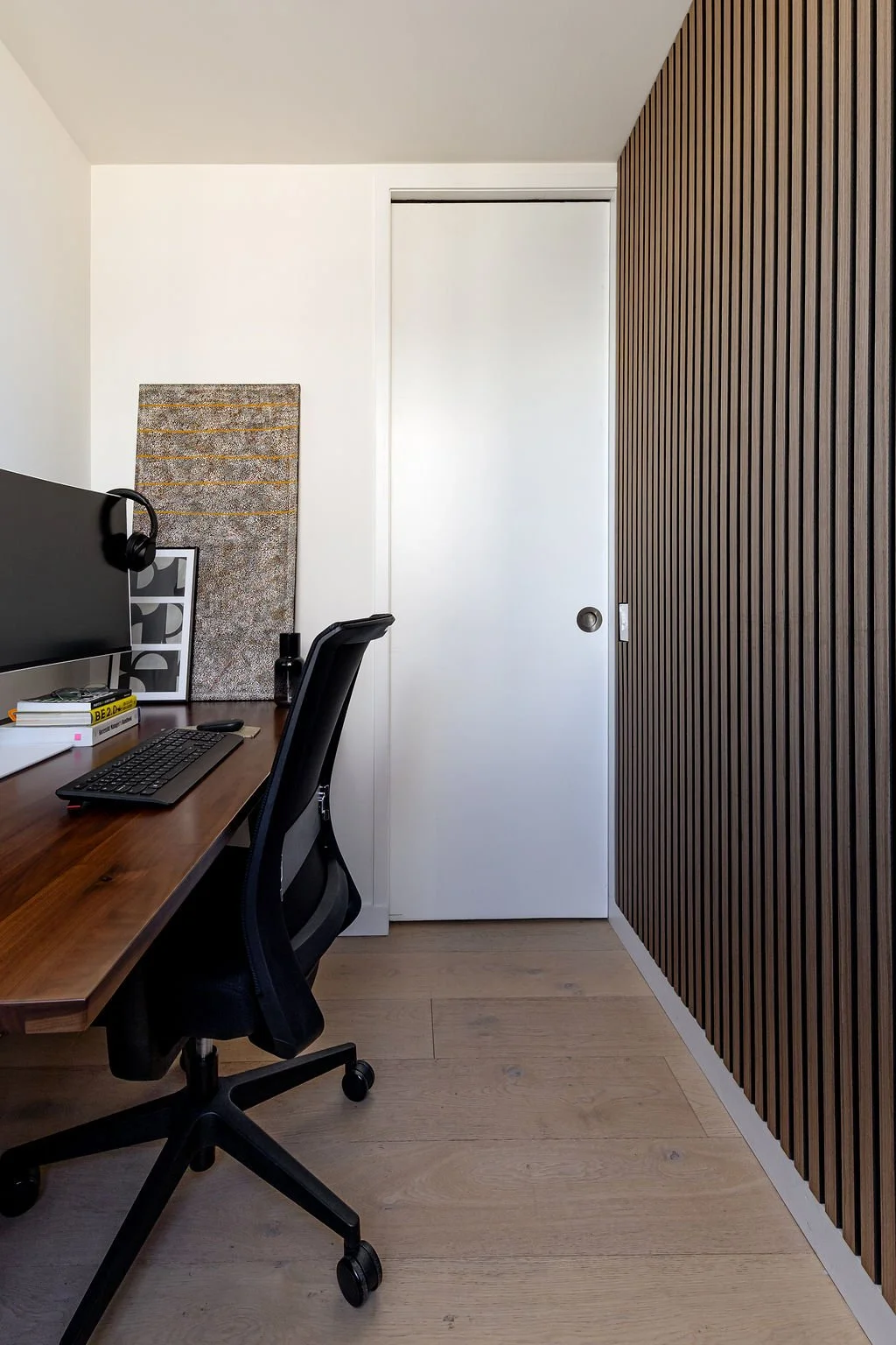 A long office space with desk and wood panelling.
