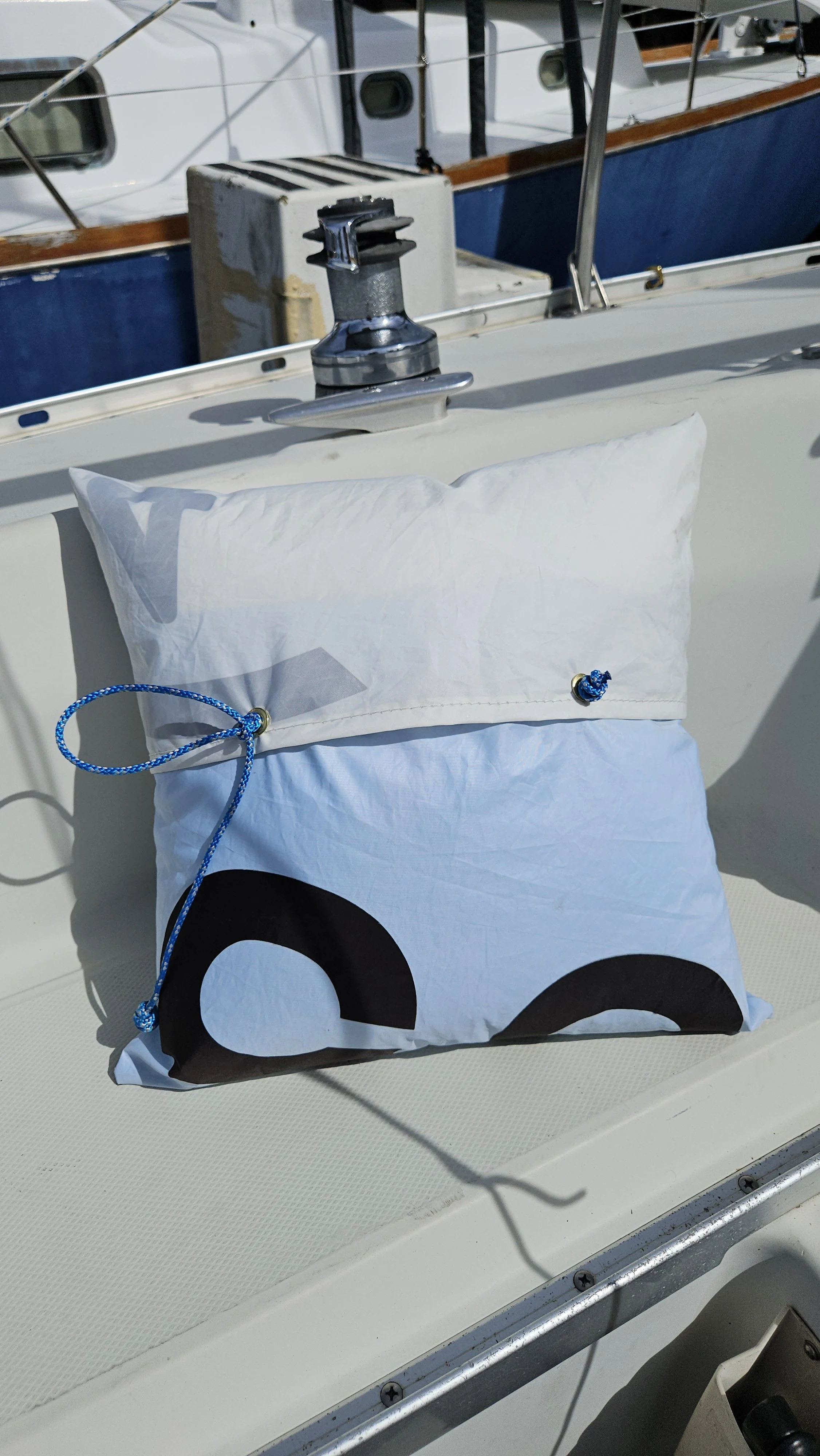 Upcycled blue and white sailcloth pillow with grommet closure