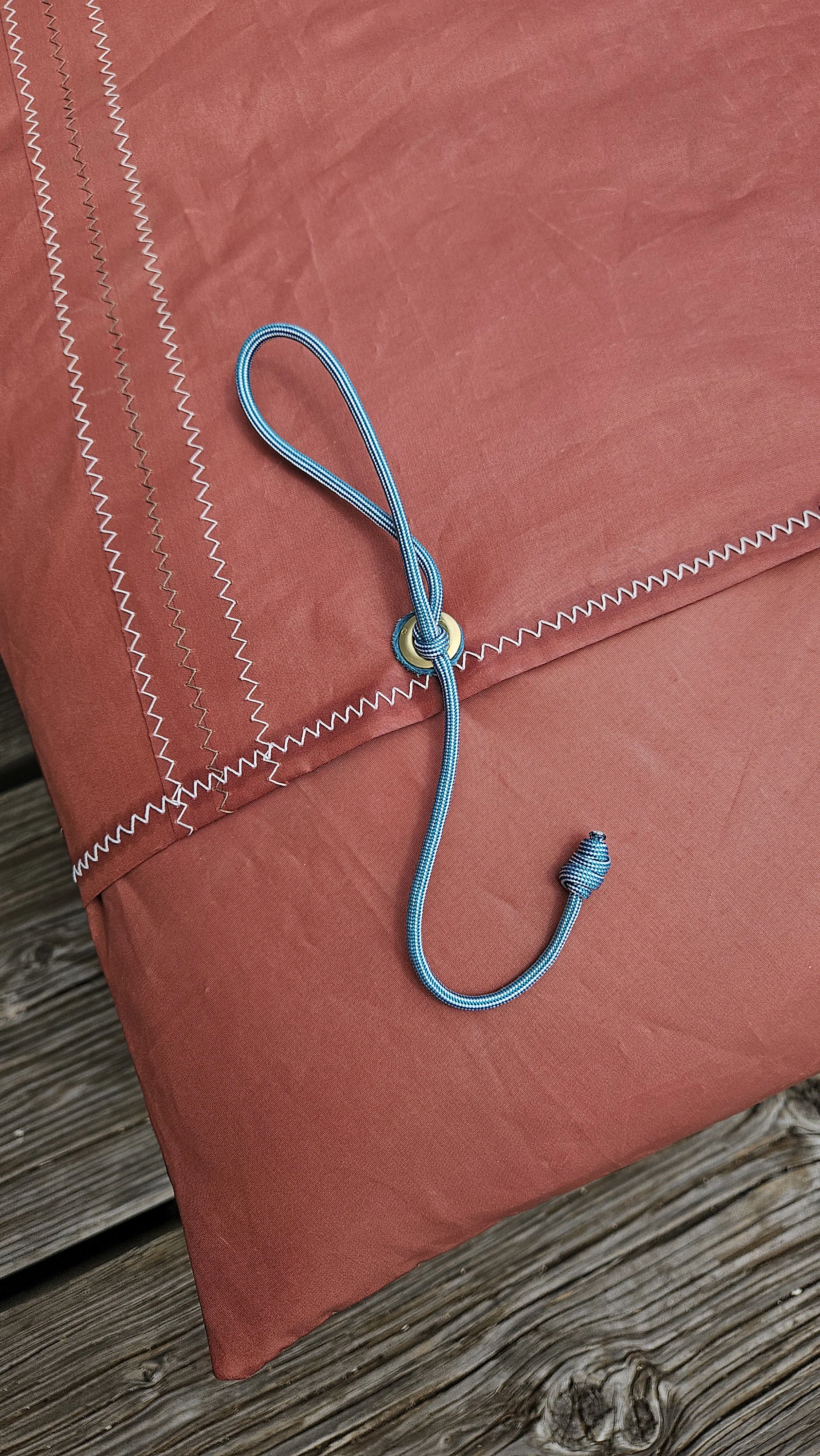 Detail of grommet and rope on tanbark sail cushion