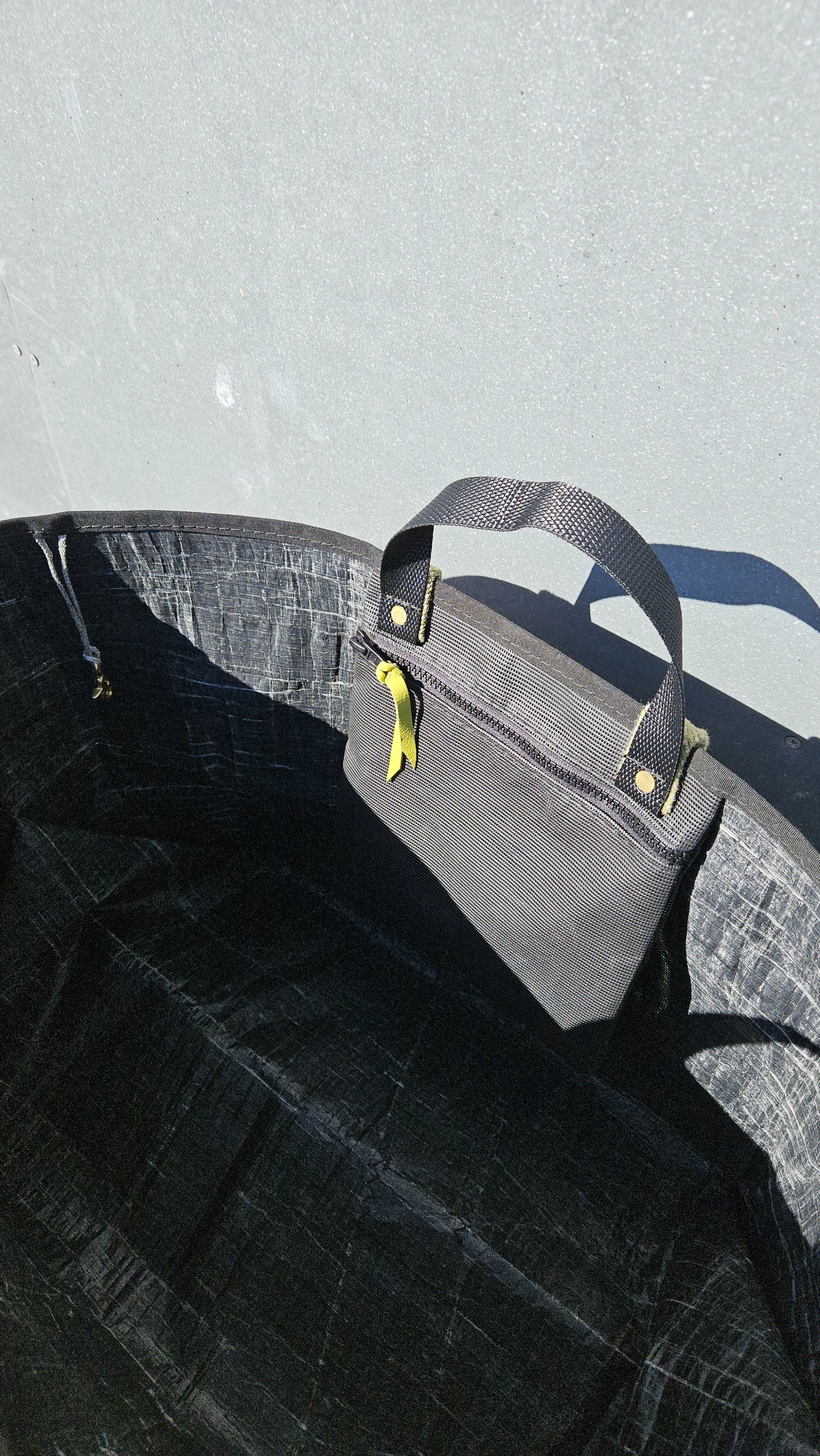 black upcycled sailcloth tote bag with interior zip pocket