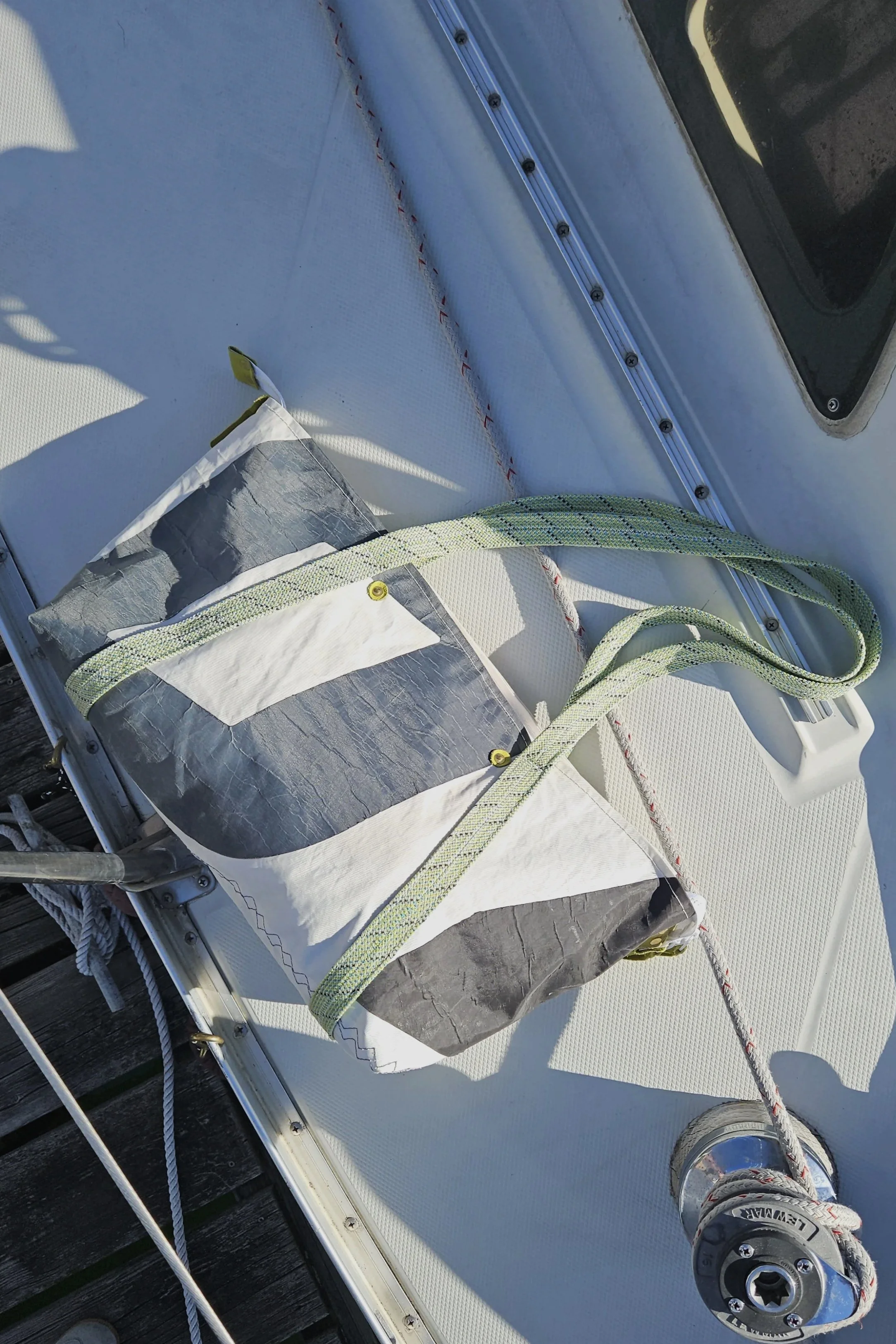 black and white sail bag with green rope straps