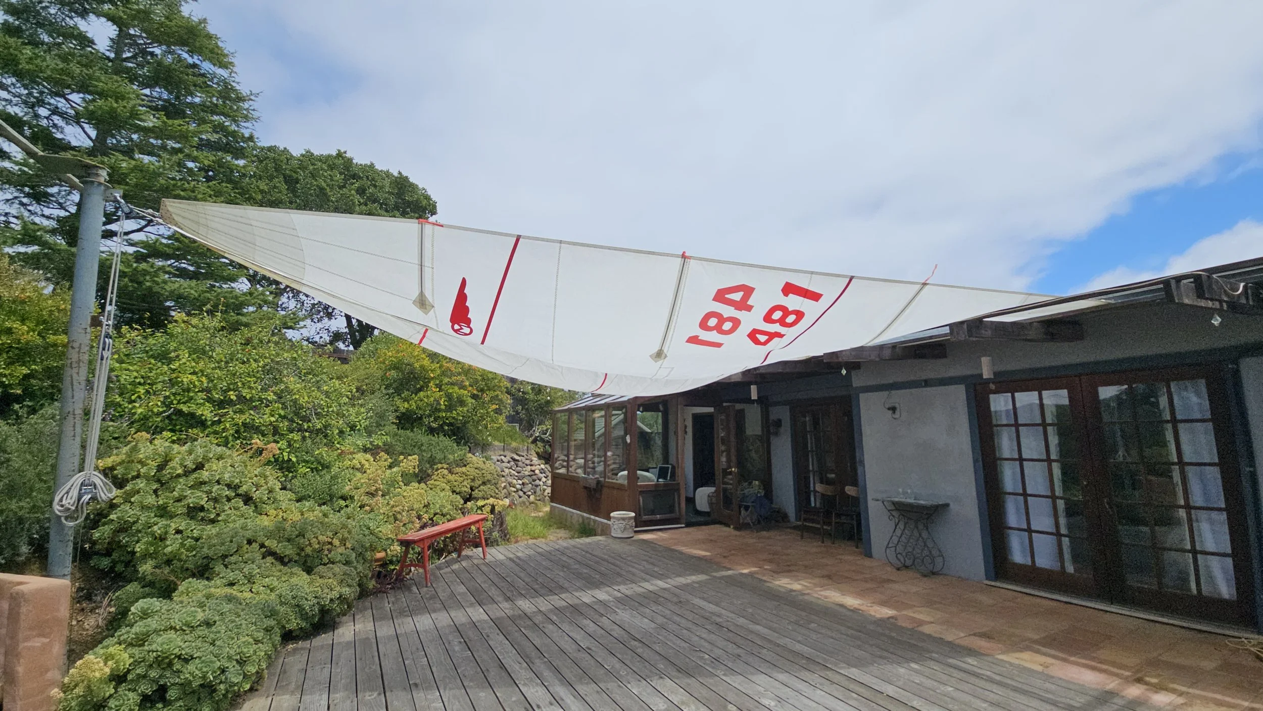 Upcycled sailcloth shade sail with pulley system.