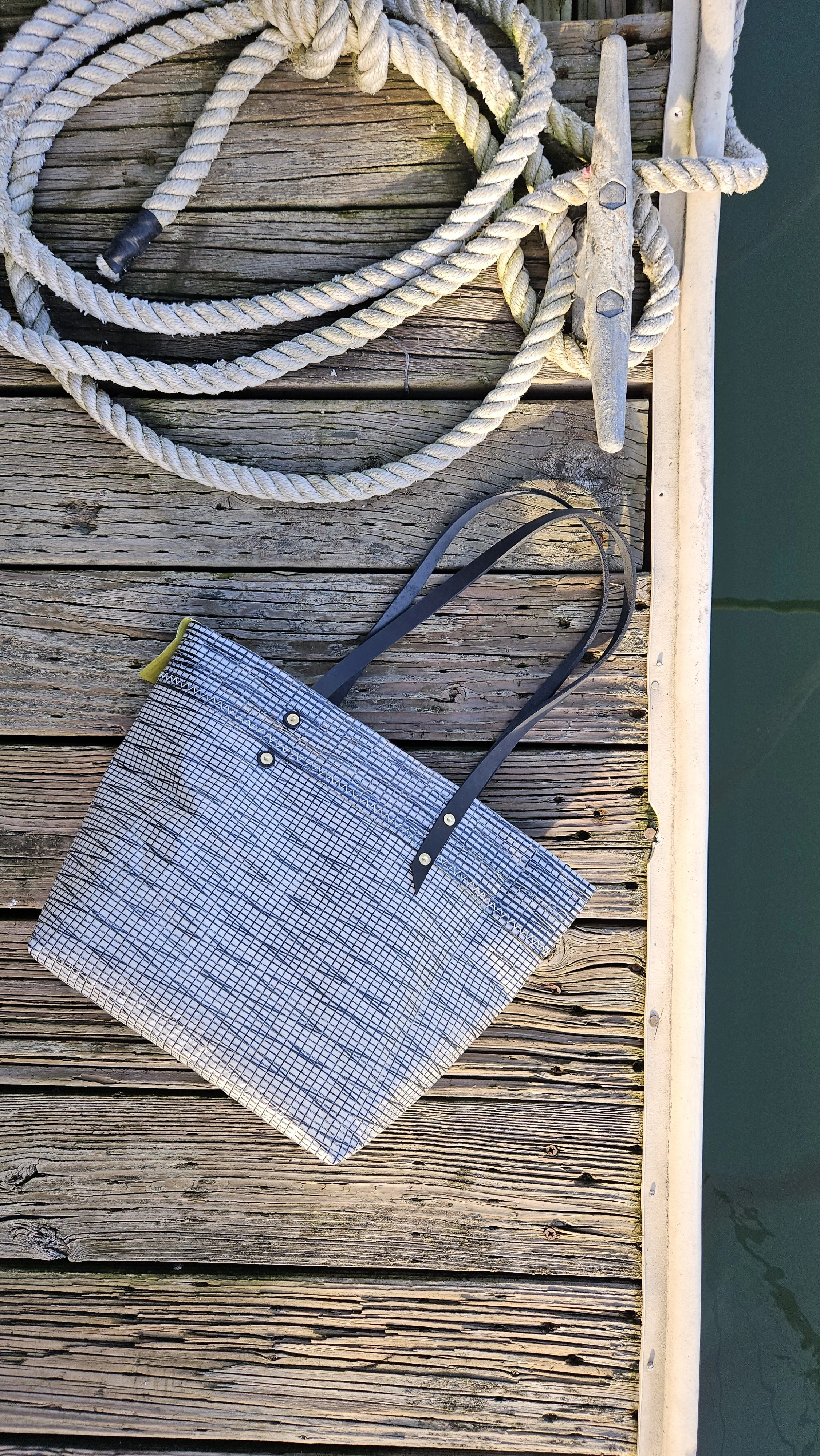 Upcycled sail bag made from black sails with leather straps