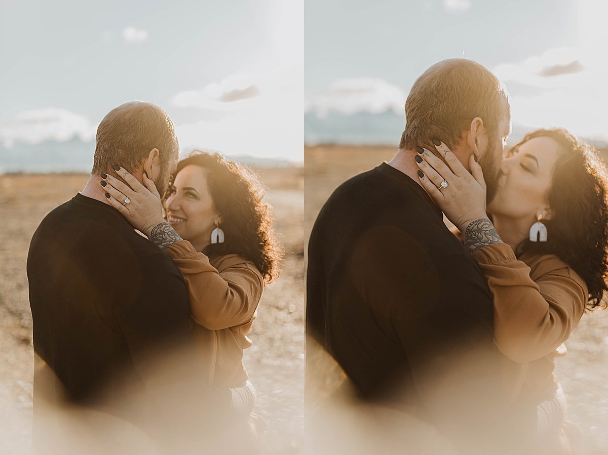  man and woman kiss during warm sunset engagement shoot in alaska mountains 