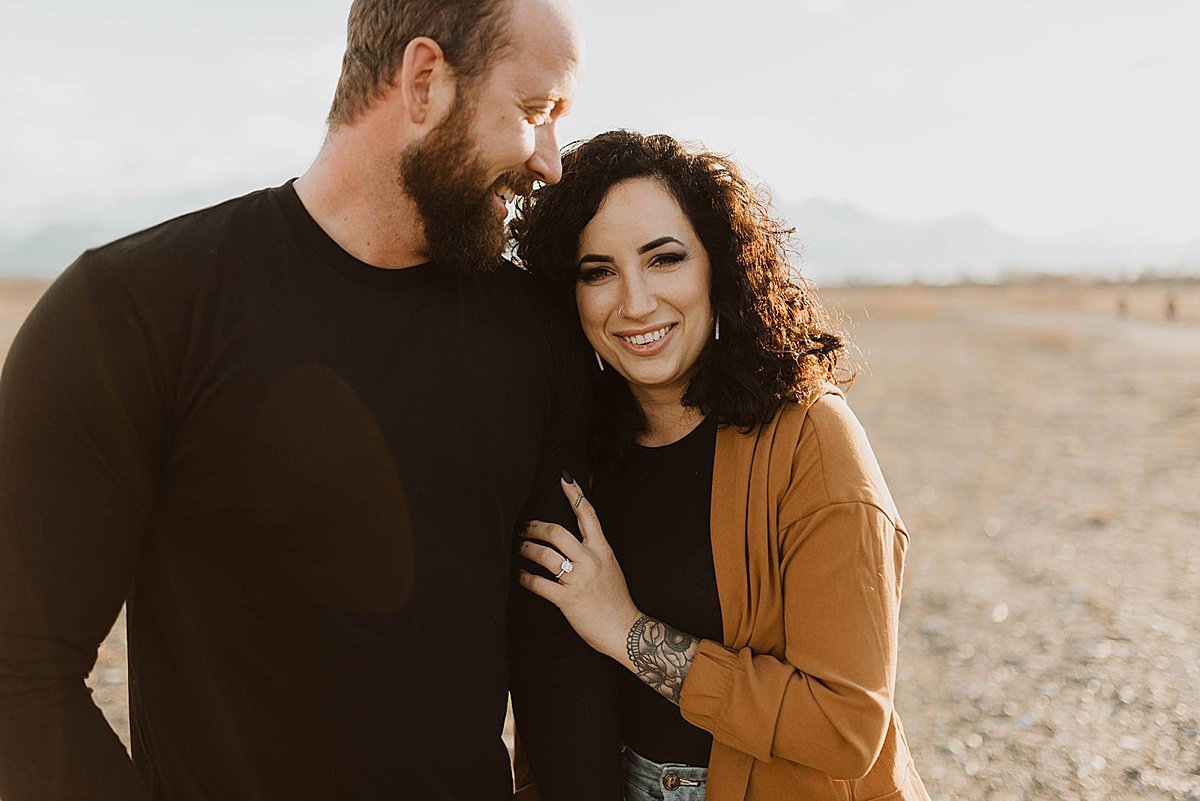  newly engaged couple smile in outdoor shoot by Alaska wedding photographer 