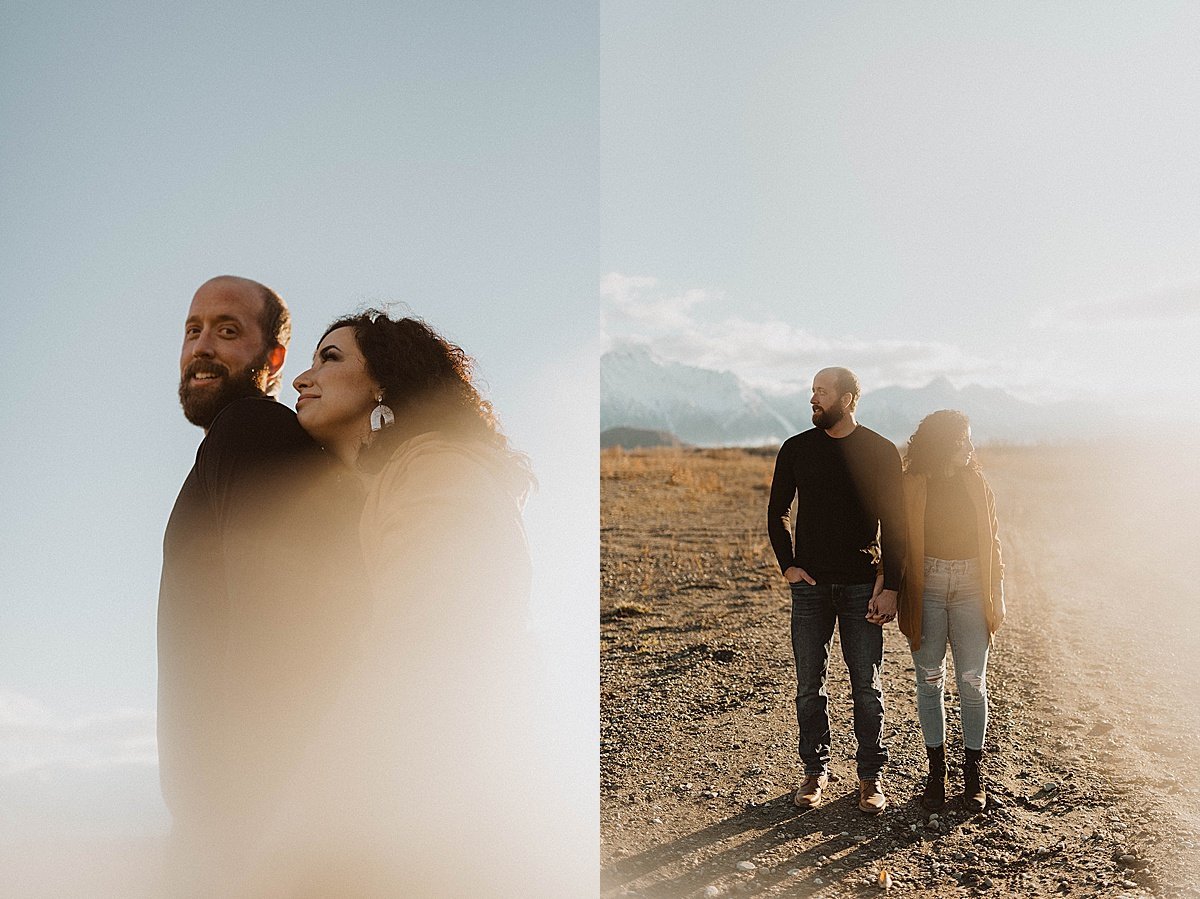  outdoorsy couple pose during warm sunset engagement shoot in alaska mountains 