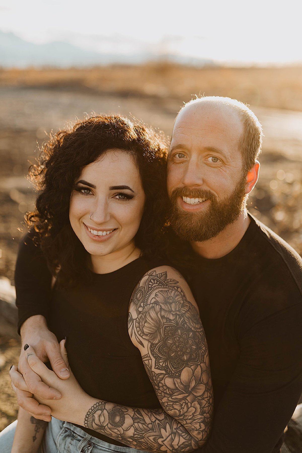  Couple with artsy tattoos poses during golden hour engagement shoot with Theresa McDonald Photography 