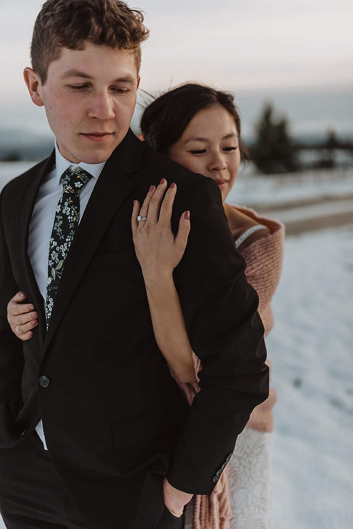  bride wearing diamond ring embraces newlywed husband during evening twilight shoot by alaska wedding photographer 