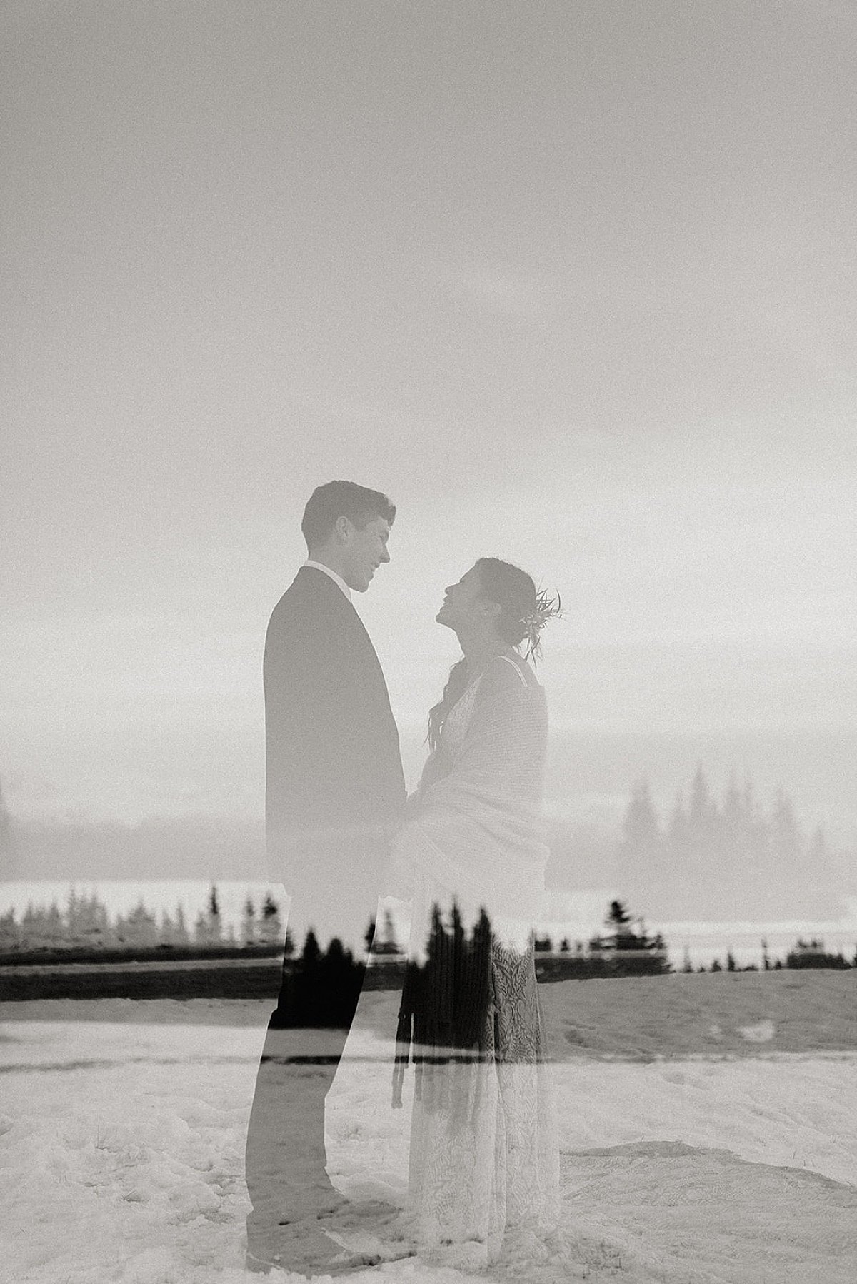  image of bride and groom superimposed on top of pine tree lake view for artsy shoot of snowy fall wedding 