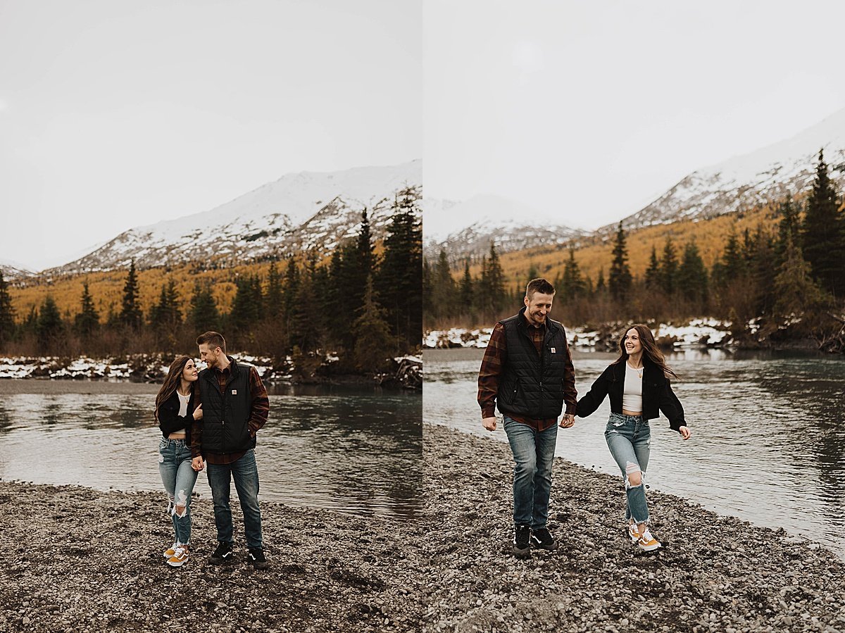  Outdoorsy couple walk along mountain lake beach in engagement shoot by Theresa McDonald photography 