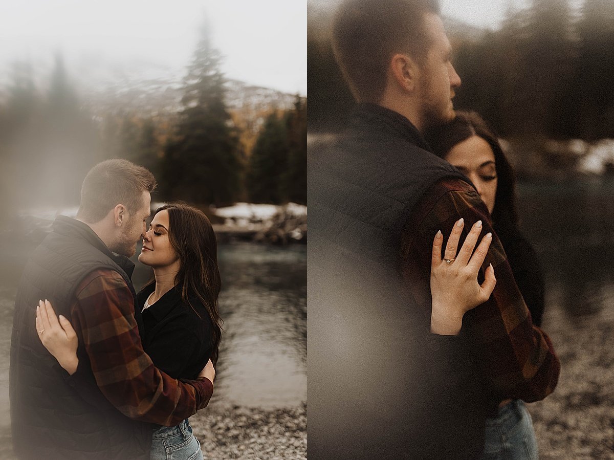  engaged couple embrace and display diamond ring at mountain lake during autumn engagement shoot 