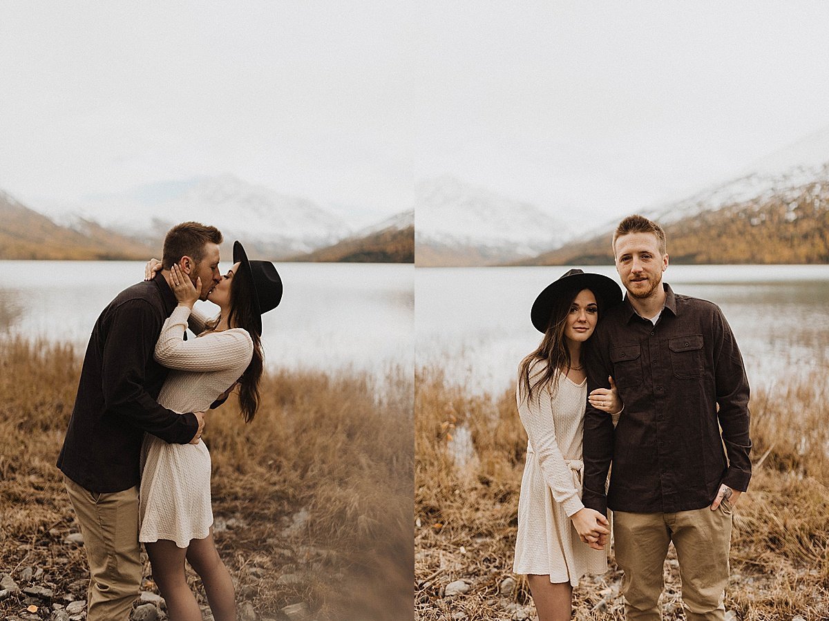  boho outdoorsy couple in felt hat and cute dress kiss at mountain adventure engagement shoot by alaska wedding photographer 