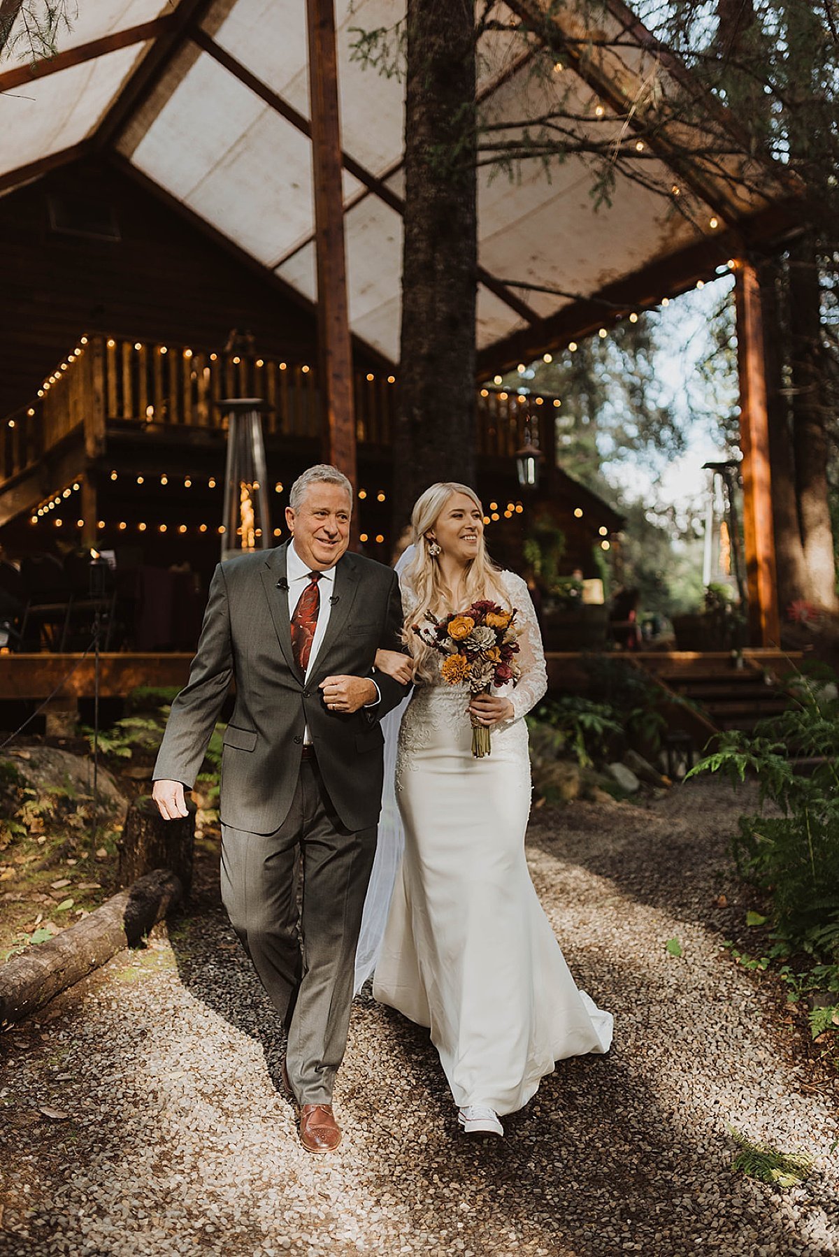  father of the bride walks daughter down the aisle at outdoor moody glacier creek wedding 