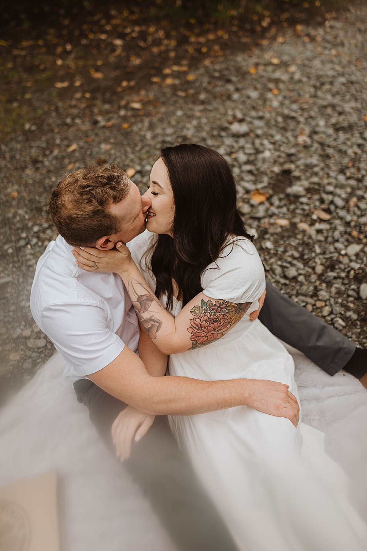  Man and woman kiss at outdoor picnic in engagement shoot in alaska 