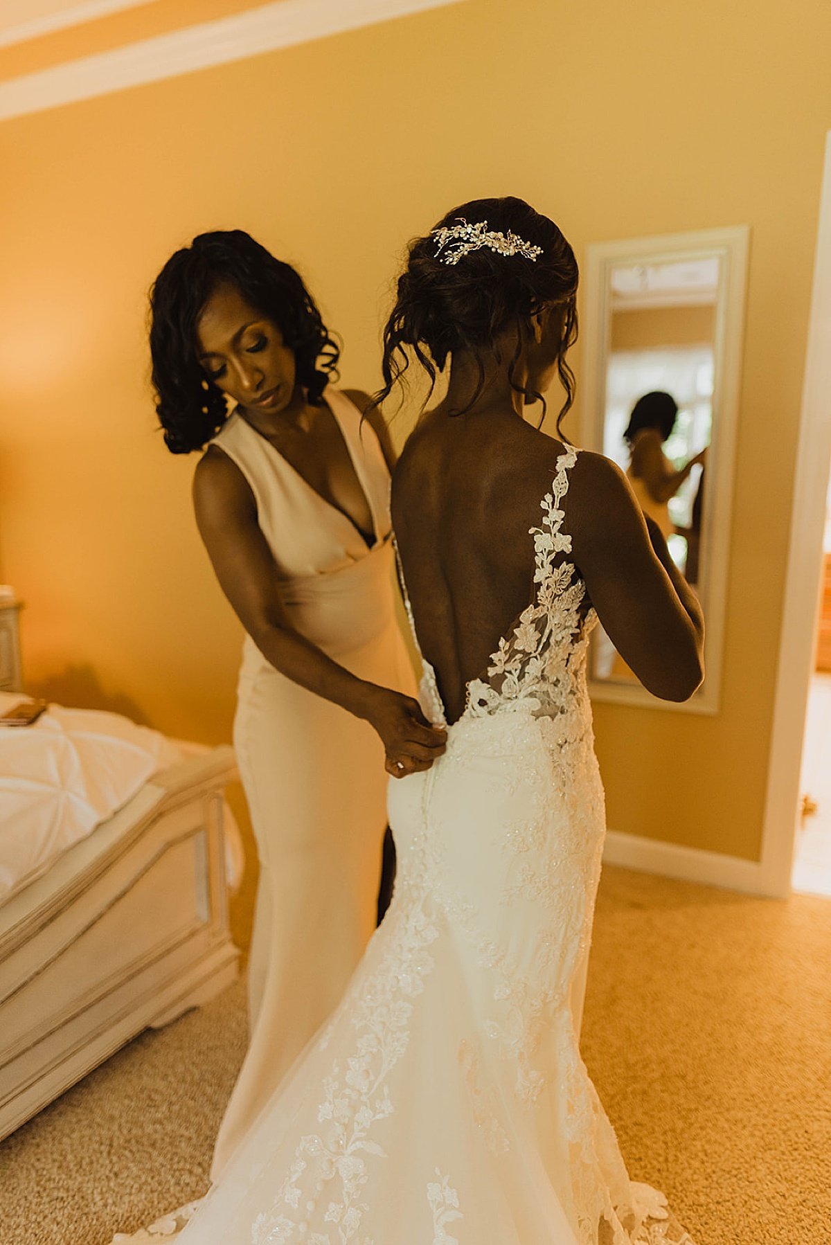  Mother of the bride helps adjust wedding dress in shoot by alaska wedding photographer  