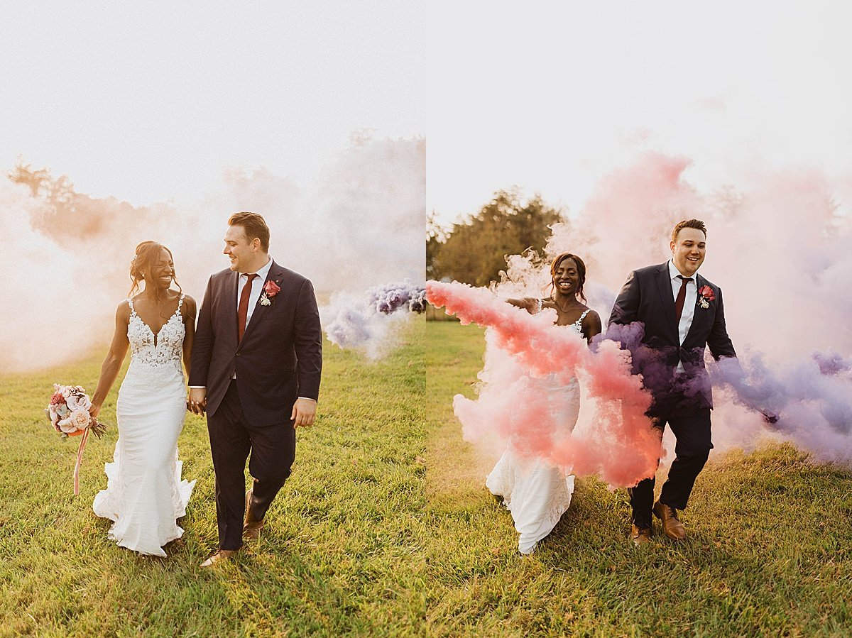  Bride and groom laughing as they run through colorful smoke at outdoor wedding 
