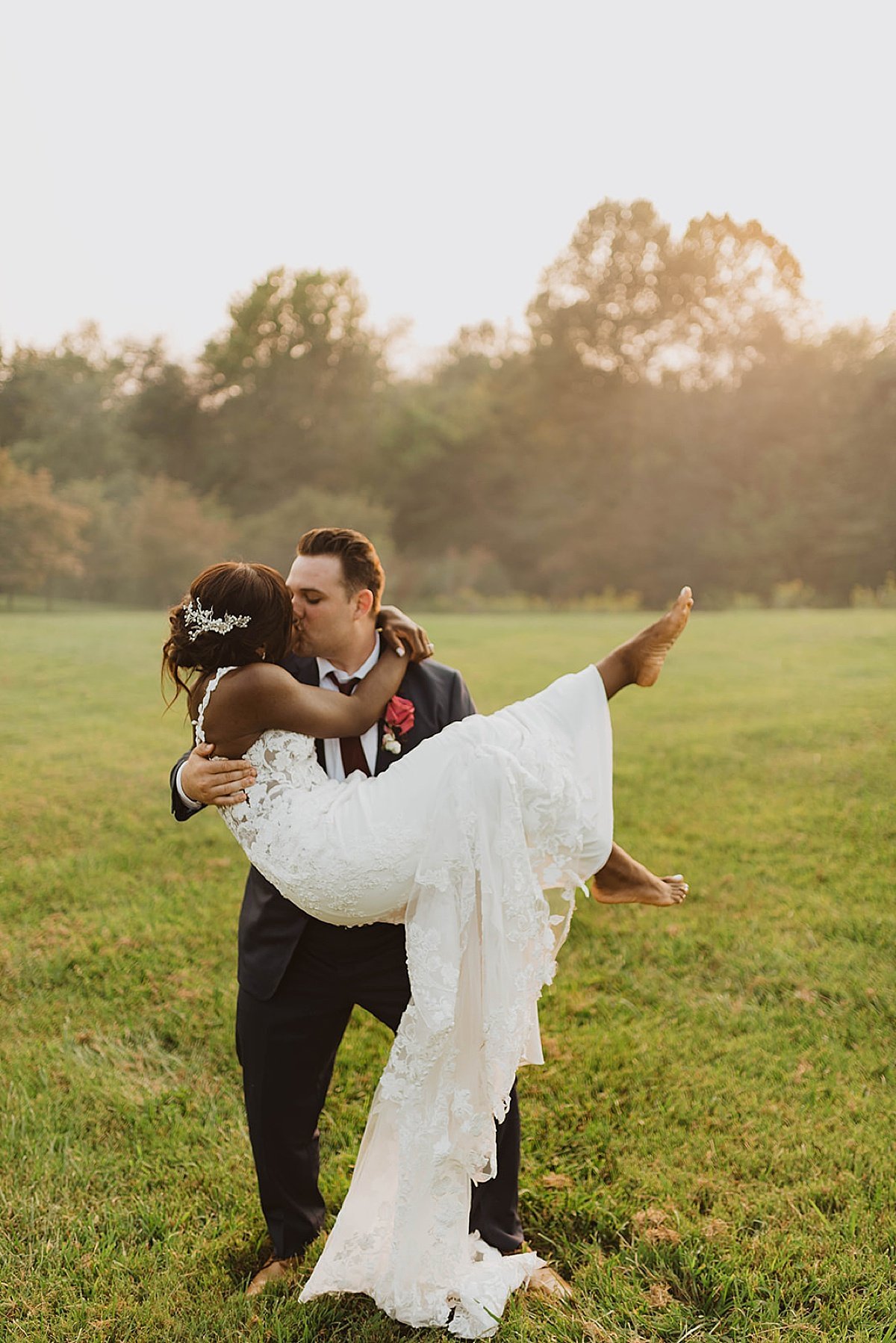  Newlywed husband sweeps wife off her feet at outdoor wedding shot by alaska wedding photographer 