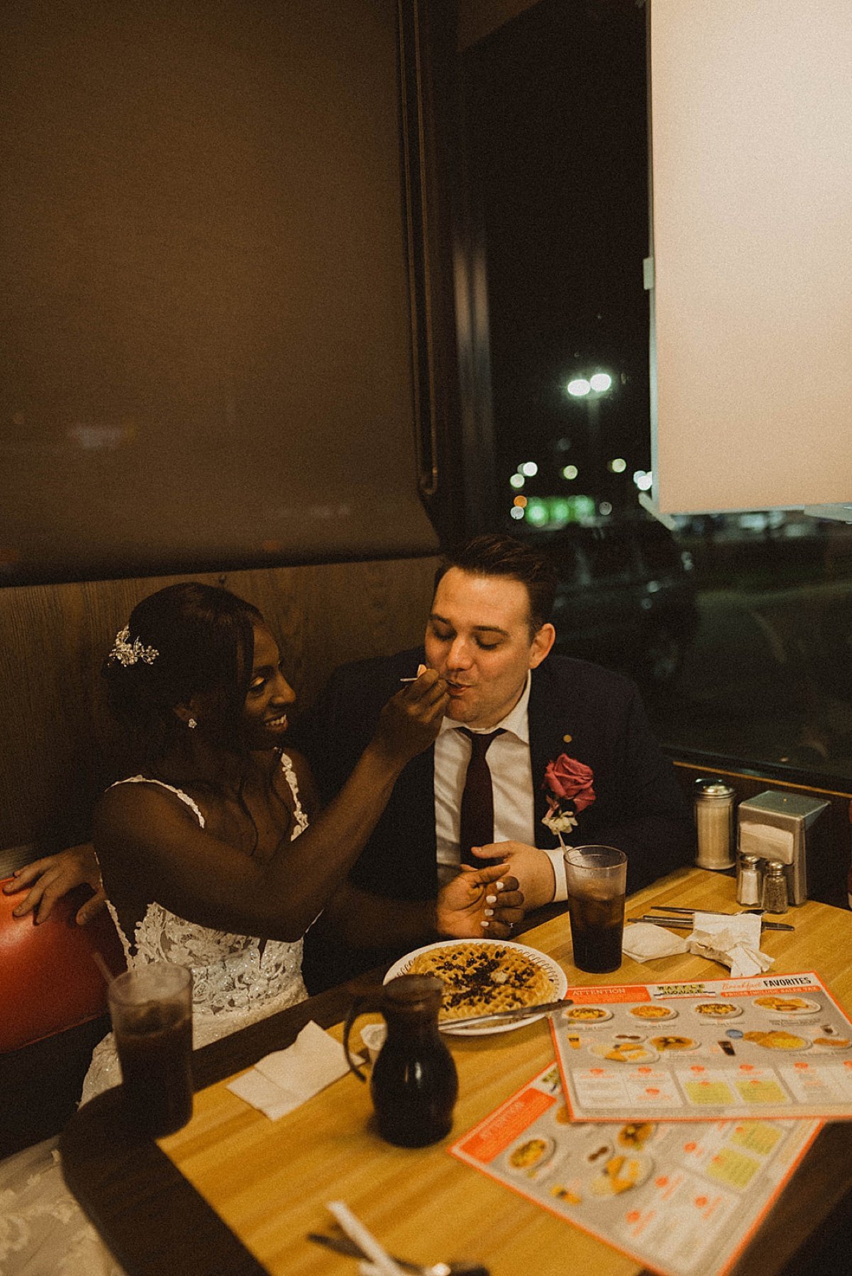  Bride and groom eat waffles at diner after wedding reception shot by theresa mcdonald 
