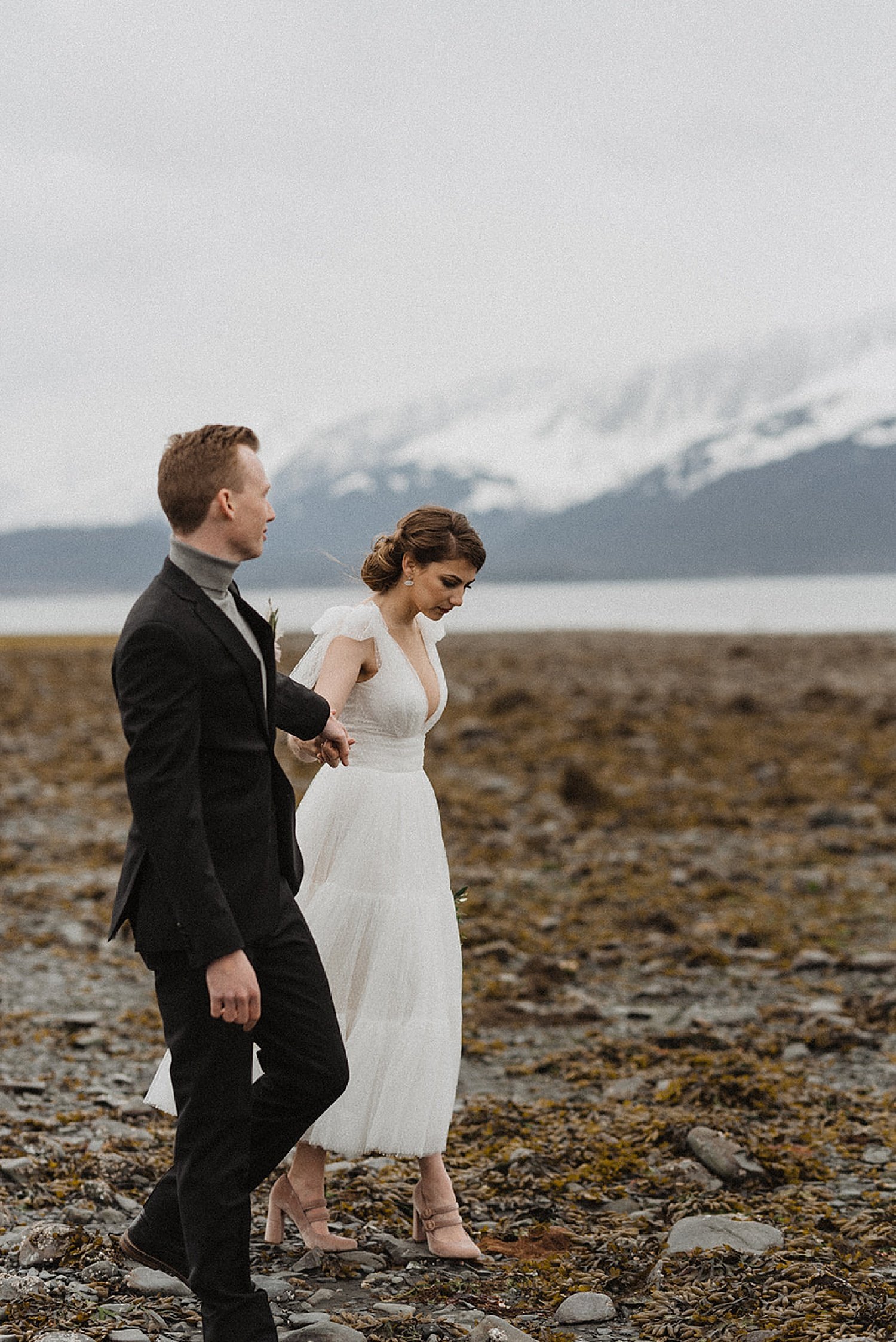  Bride and groom walk the beach in styled photo shoot by alaska wedding photographer 