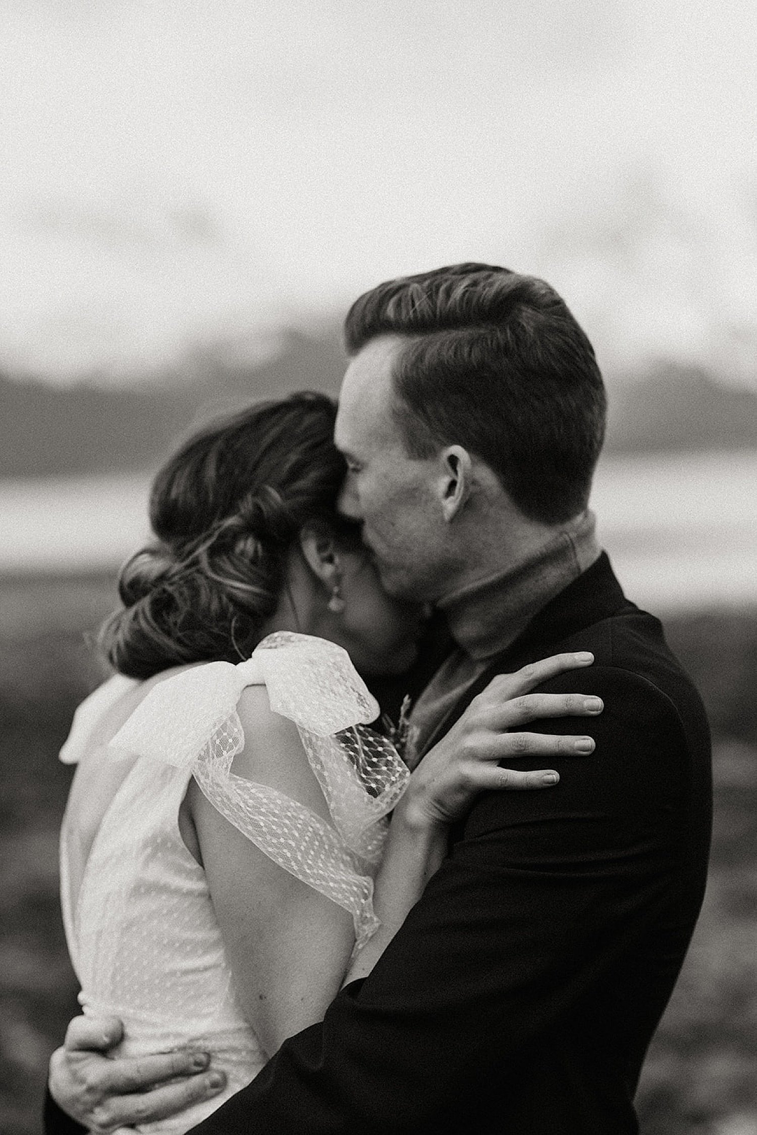  black and white wedding photo of bride and groom embracing at moody seward, alaska vintage styled shoot 