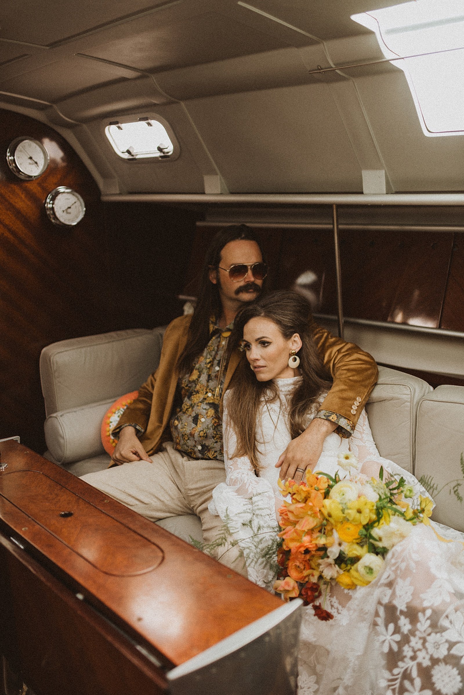  Couple curled up on a boat at their Retro Seward Styled Shoot 