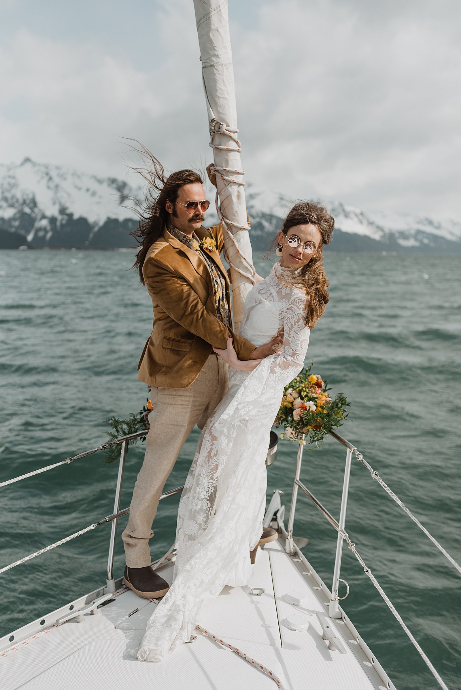  Bride and groom in 70s attire on a boat in Seward 