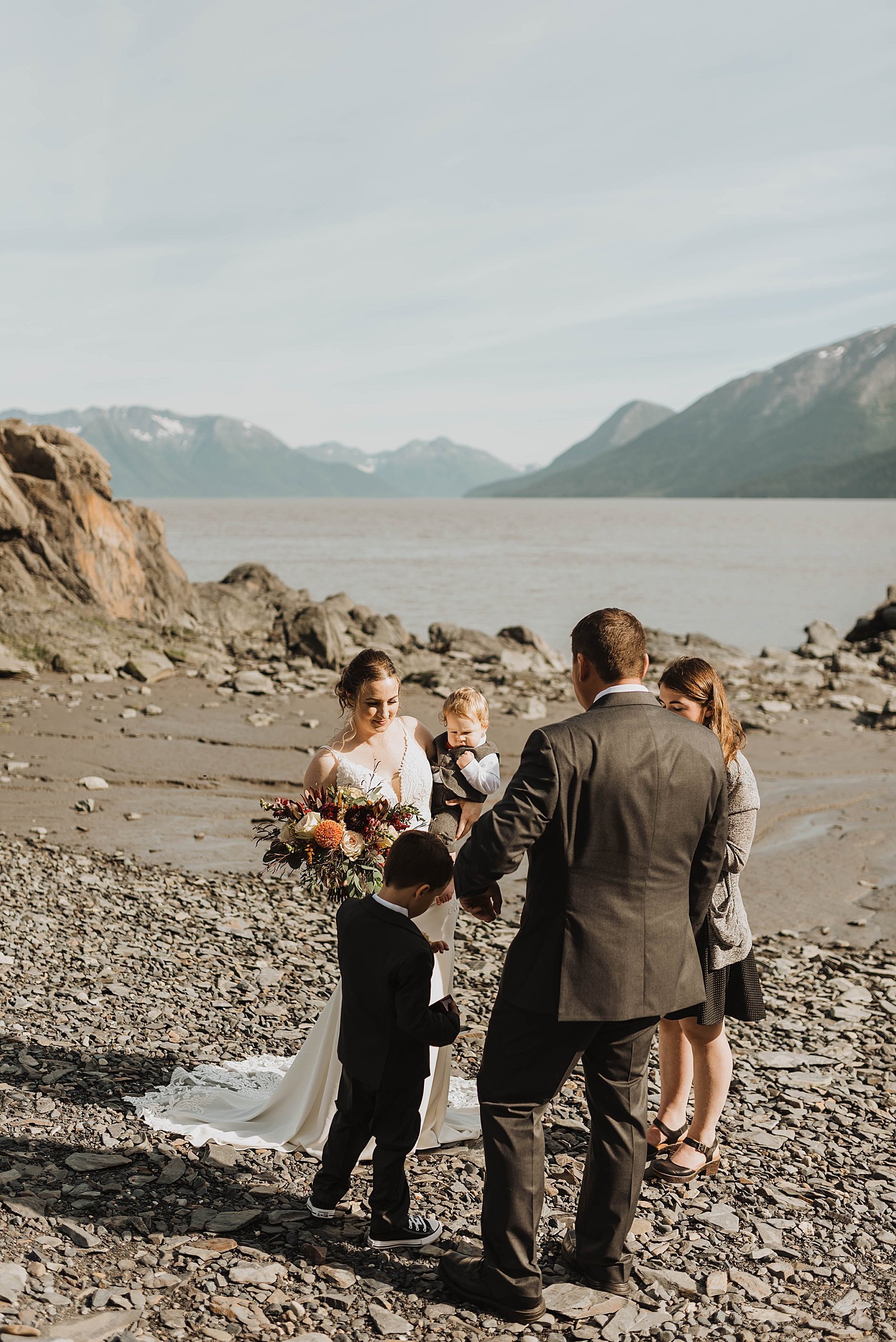  Bride and groom at a private ceremony on a beach in Alaska 