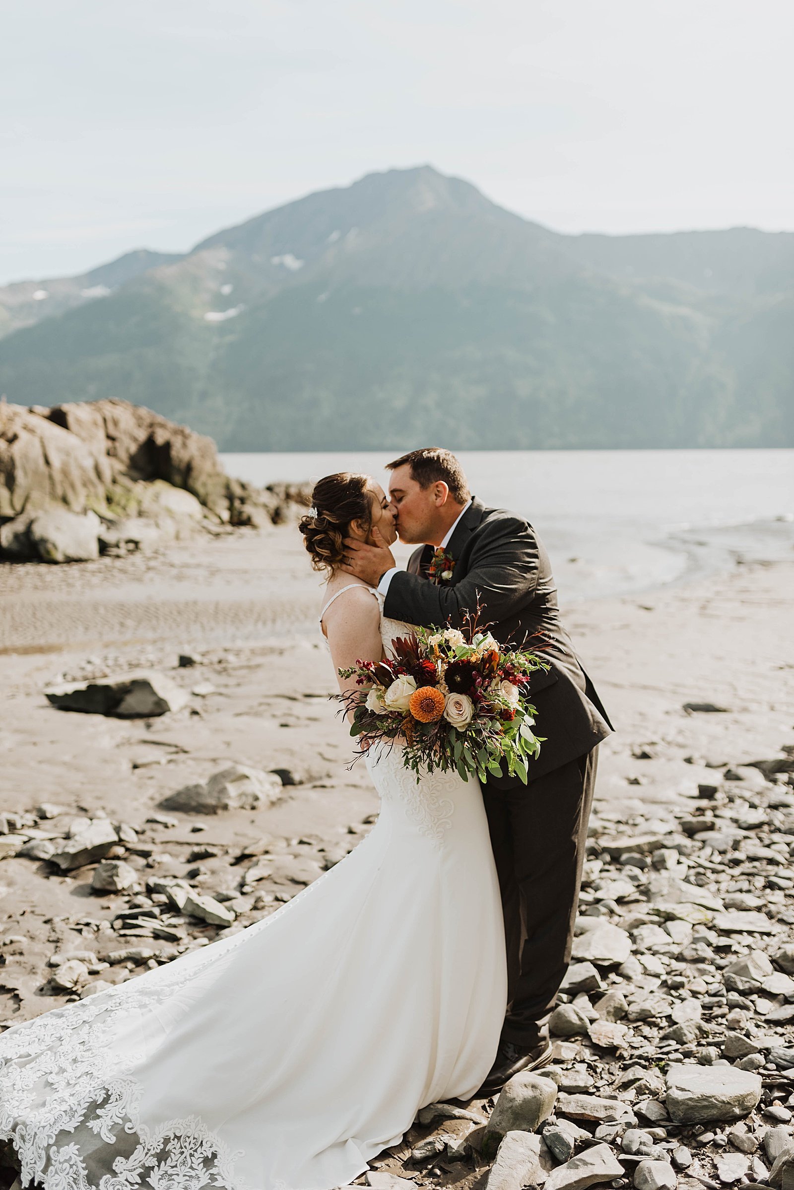  Bride and groom kissing after their wedding ceremony in Alaska  