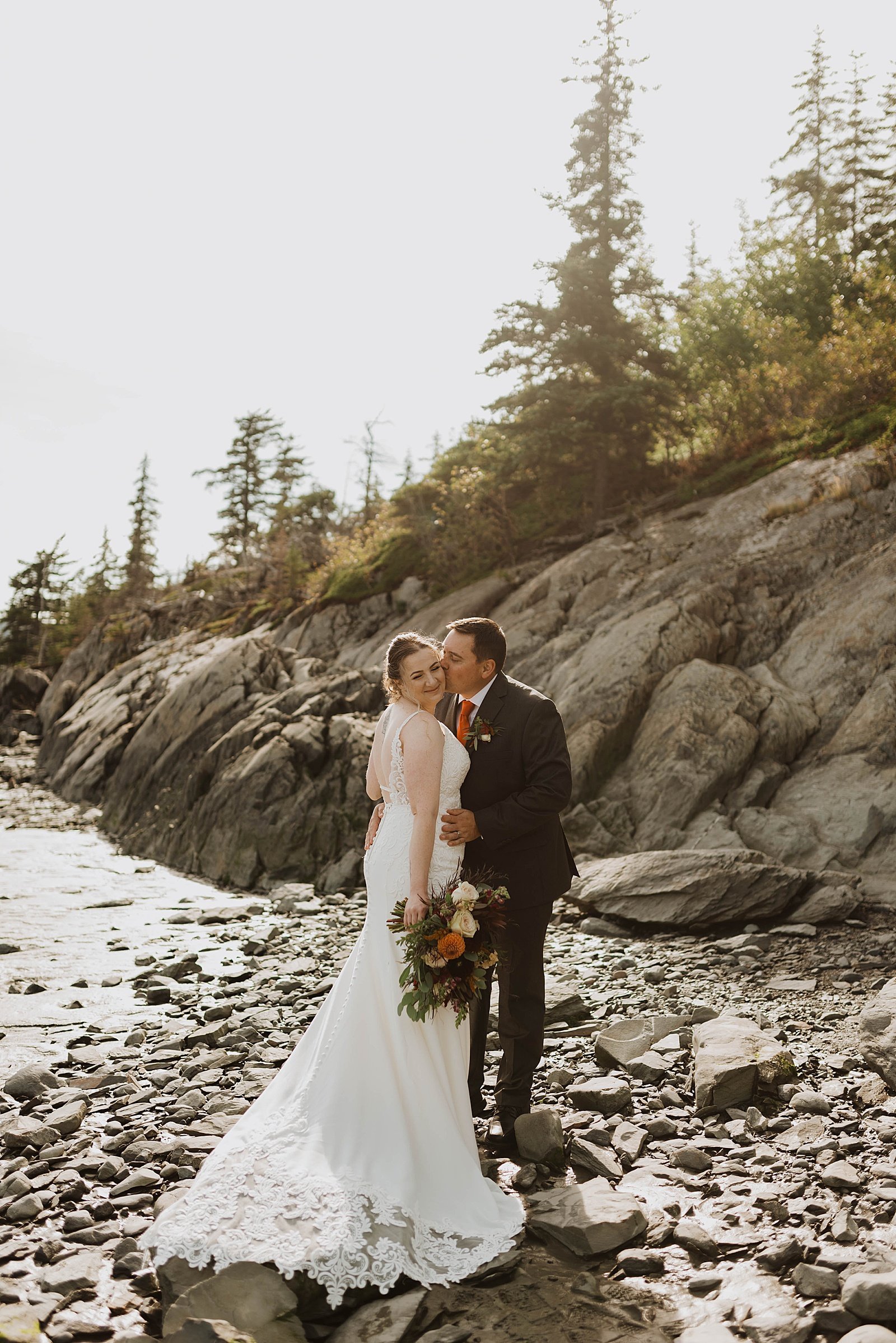  Couple in Alaska sharing a kiss after intimate wedding 