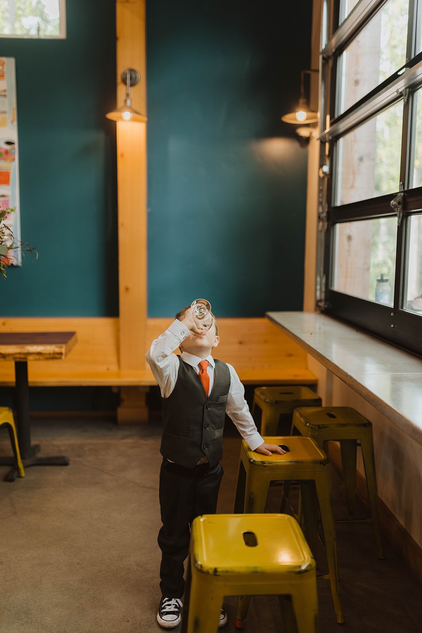  Toddler sipping root beer at a brewery in Alaska during his parents wedding  