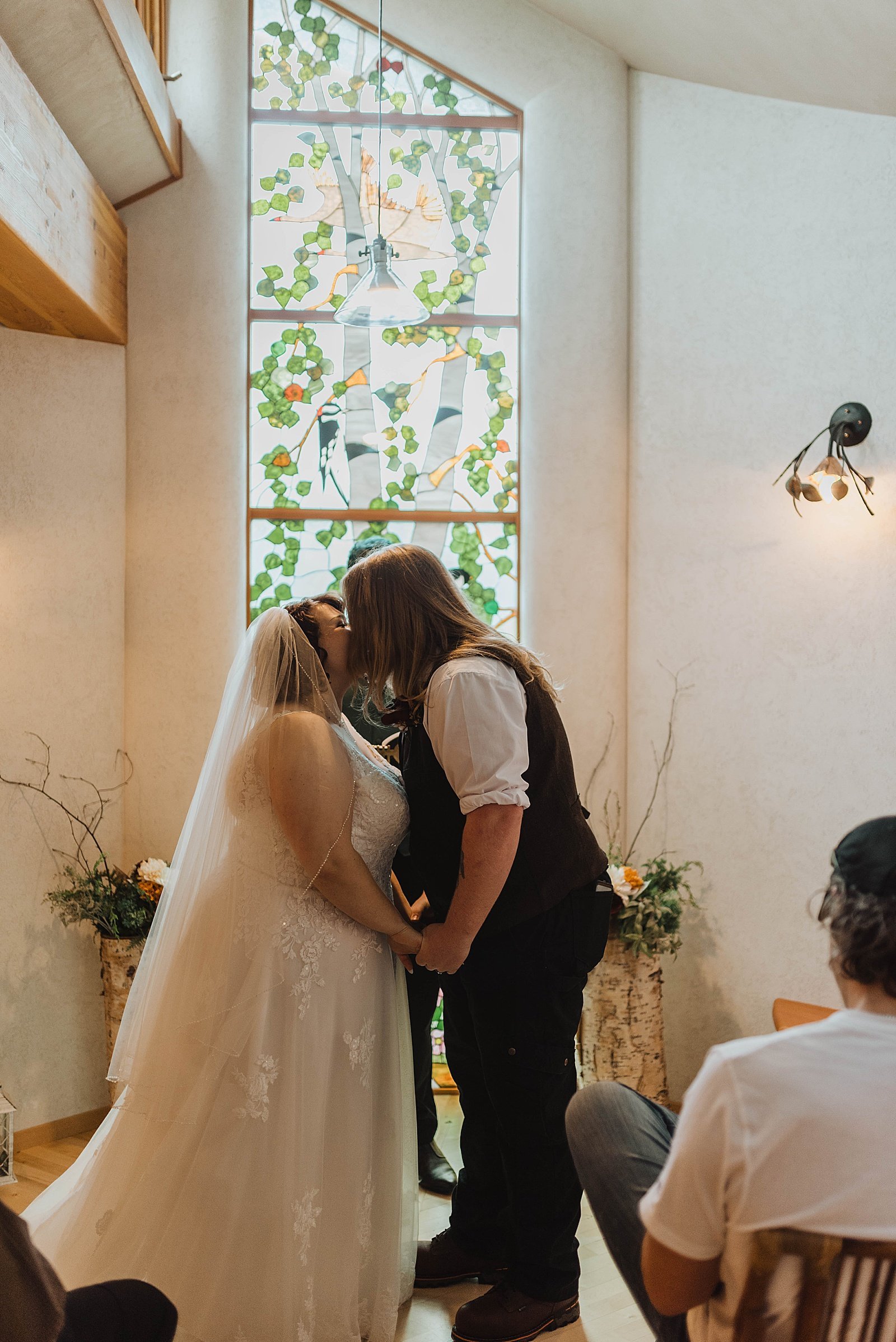  Newlyweds share a first kiss at the alter at their tiny wedding 