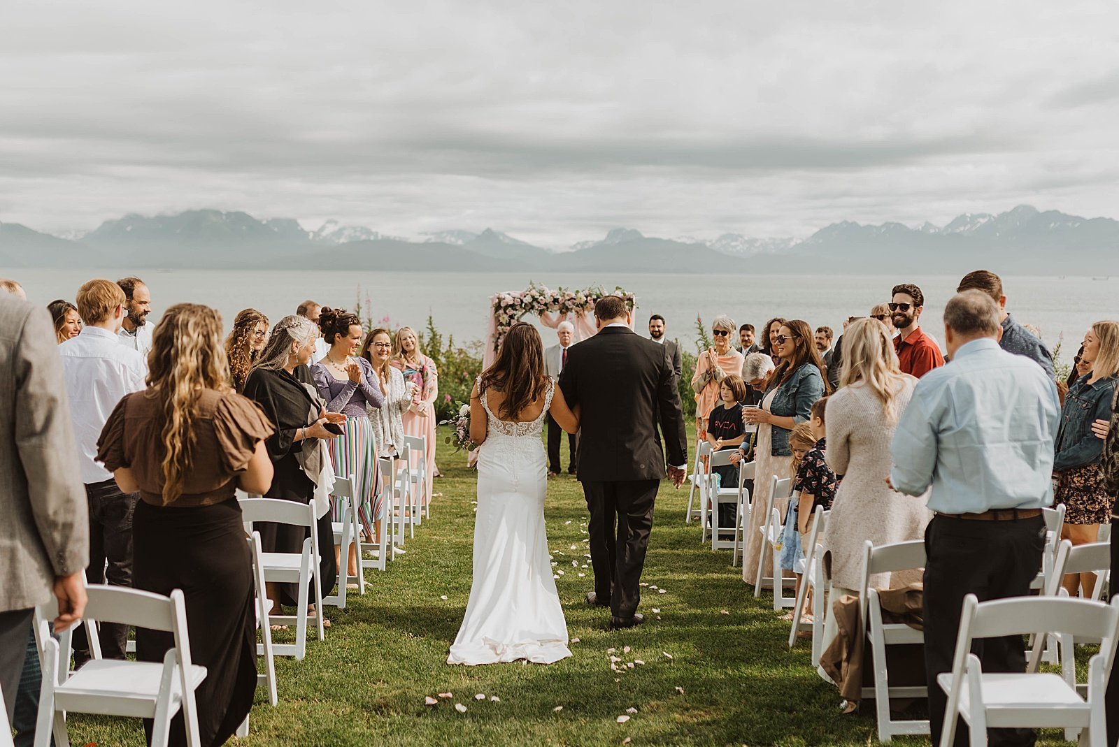  Bride walking down the aisle at her outdoor Summer Alaska ceremony 