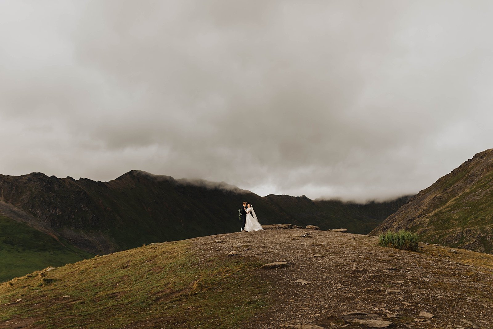  Wedding couple standing on top of a mountain at Hatcher Pass in Alaska. 