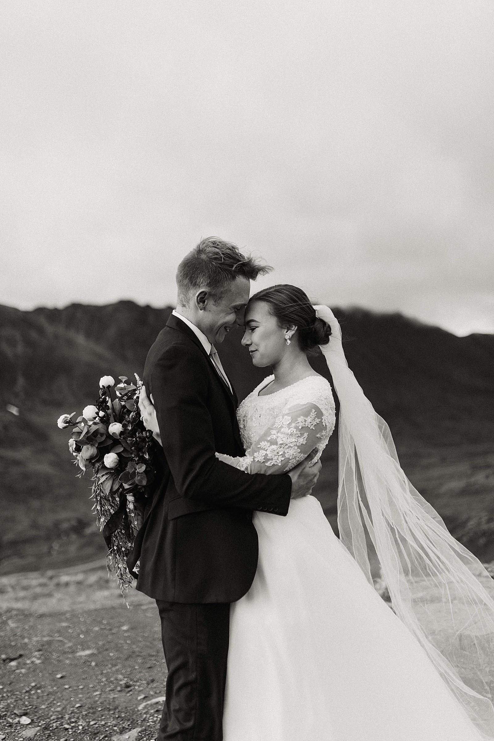  Bride and groom embrace for their anniversary session in Alaska 