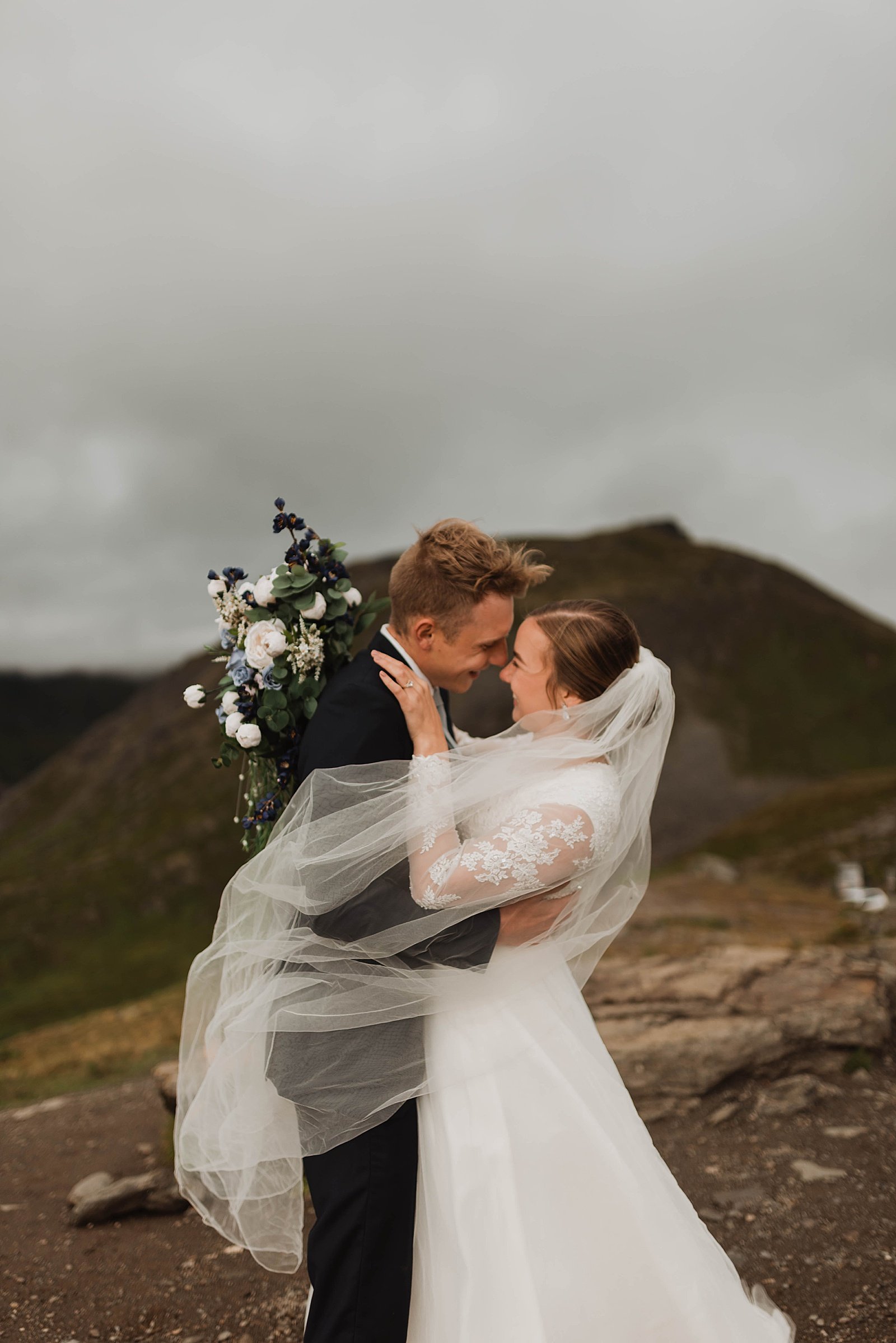 Bride and groom embracing on an Alaska mountaintop for a couple portrait session.  