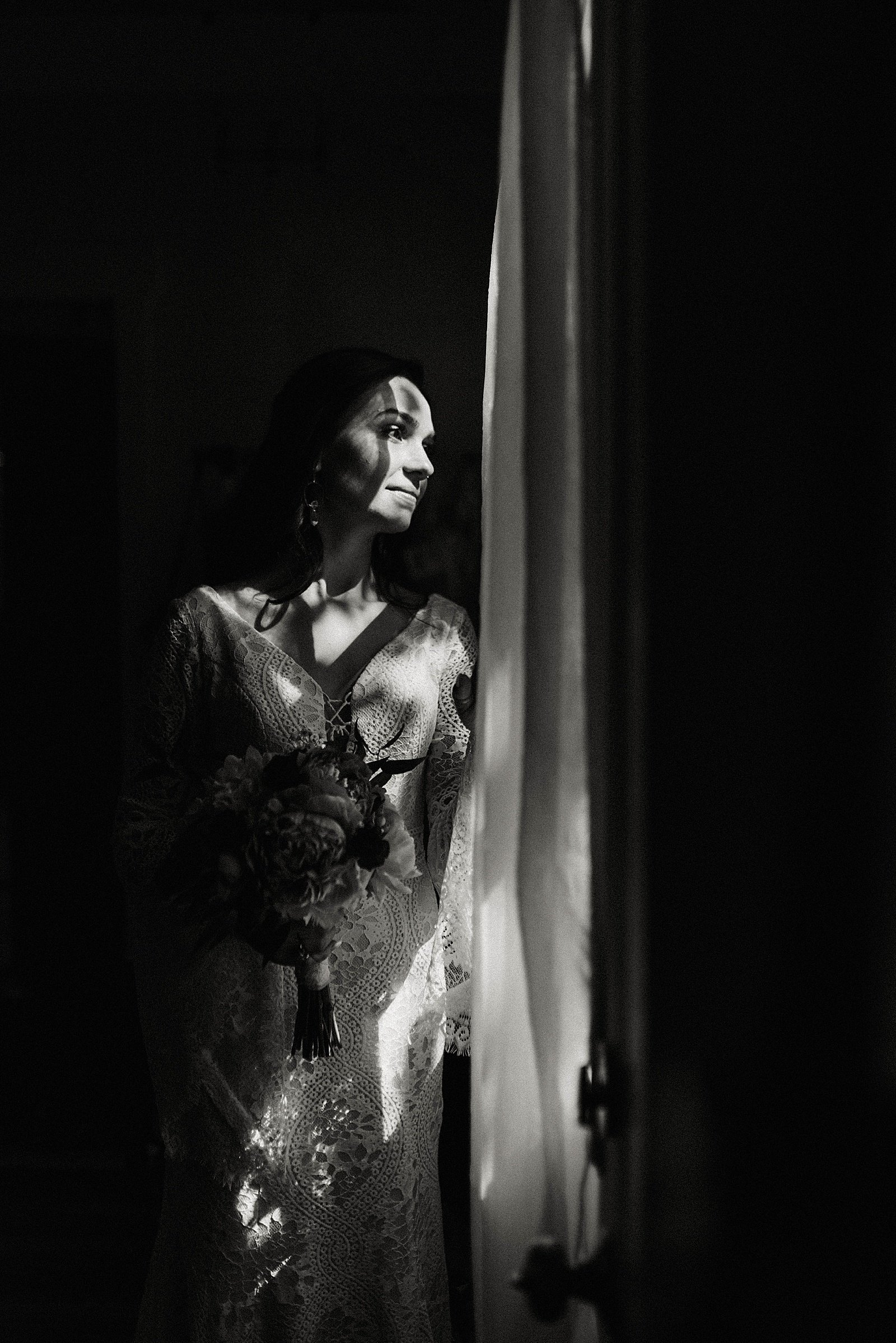  Bride standing by the window and looking out for her wedding &amp; llamas event.  